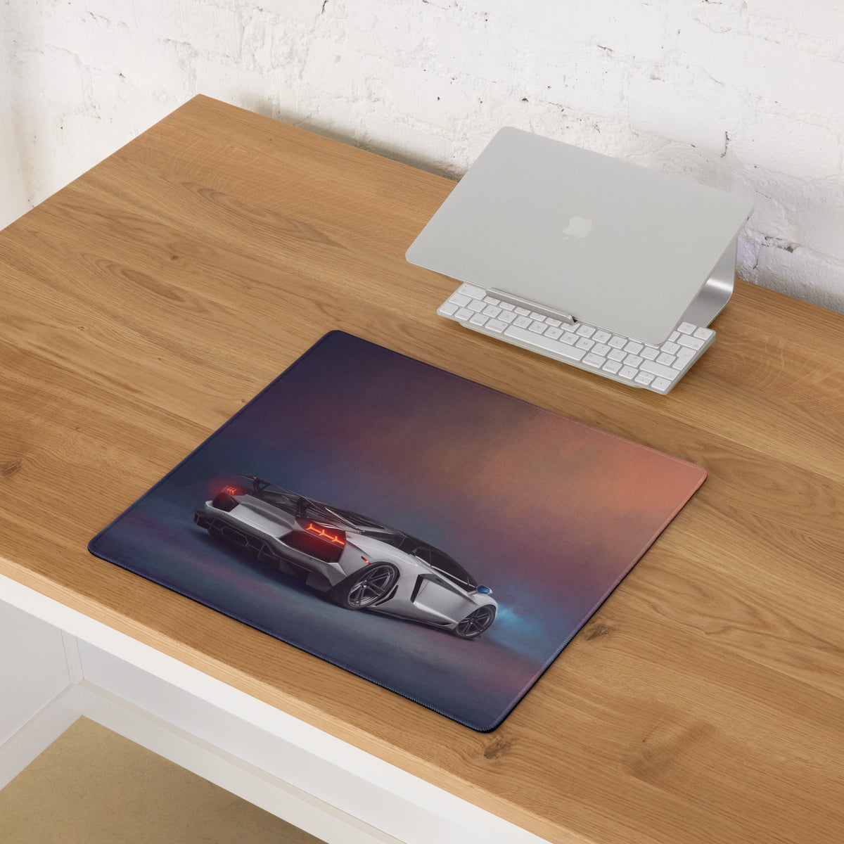 A sleek rectangular non-slip desk pad featuring a detailed white Lamborghini Aventador with glowing red taillights