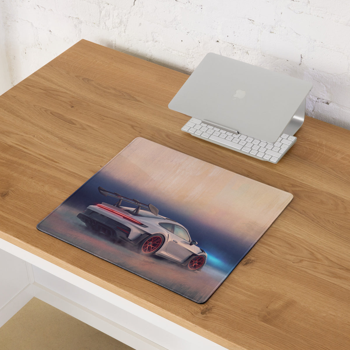 Rectangular low-friction cloth mousepad featuring a silver porsche 911 gt3 rs with red wheels and glowing taillights
