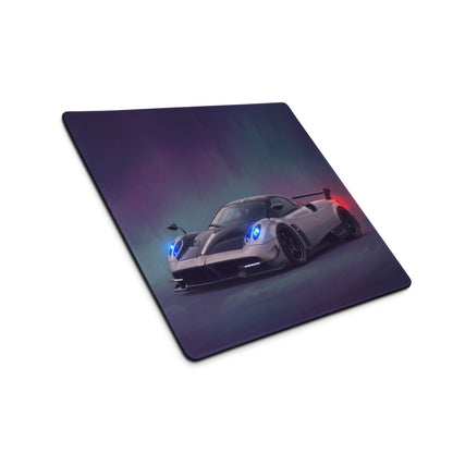 A sleek silver carbon pagani huayra inspired extended non slip desk pad with vibrant digital sports car illustration