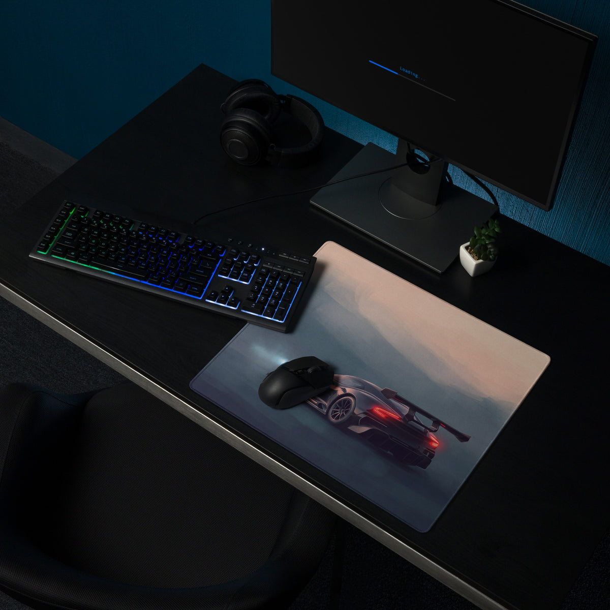 Aston Martin Vulcan inspired onyx track desk mat with sleek black sports car graphic and glowing red taillights on cloth surface