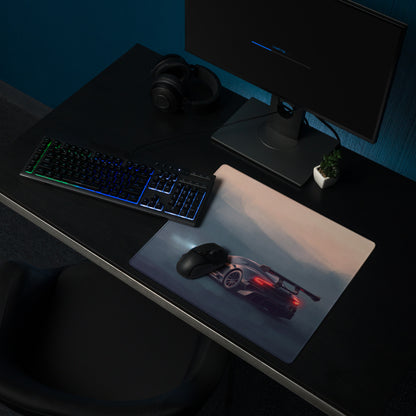 Aston Martin Vulcan inspired onyx track desk mat with sleek black sports car graphic and glowing red taillights on cloth surface