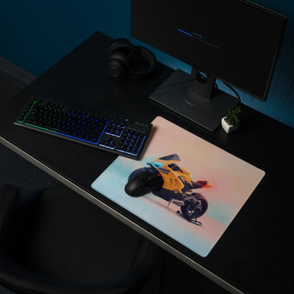 A rectangular gaming desk mat with a vibrant yellow Ducati Panigale inspired motorcycle illustration and soft gradient background