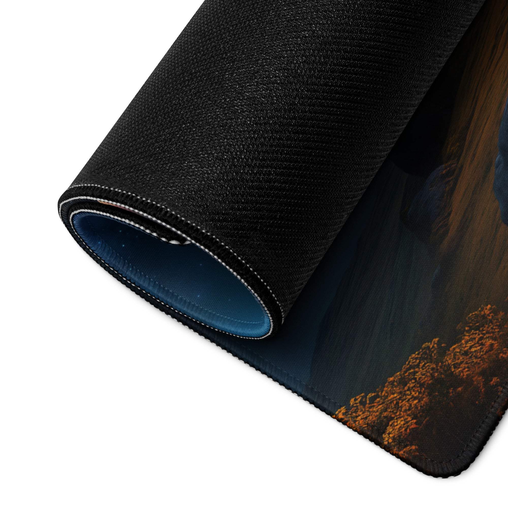 Black textured gaming mousepad with rolled edge, epic fantasy forest in orange blue night sky tones