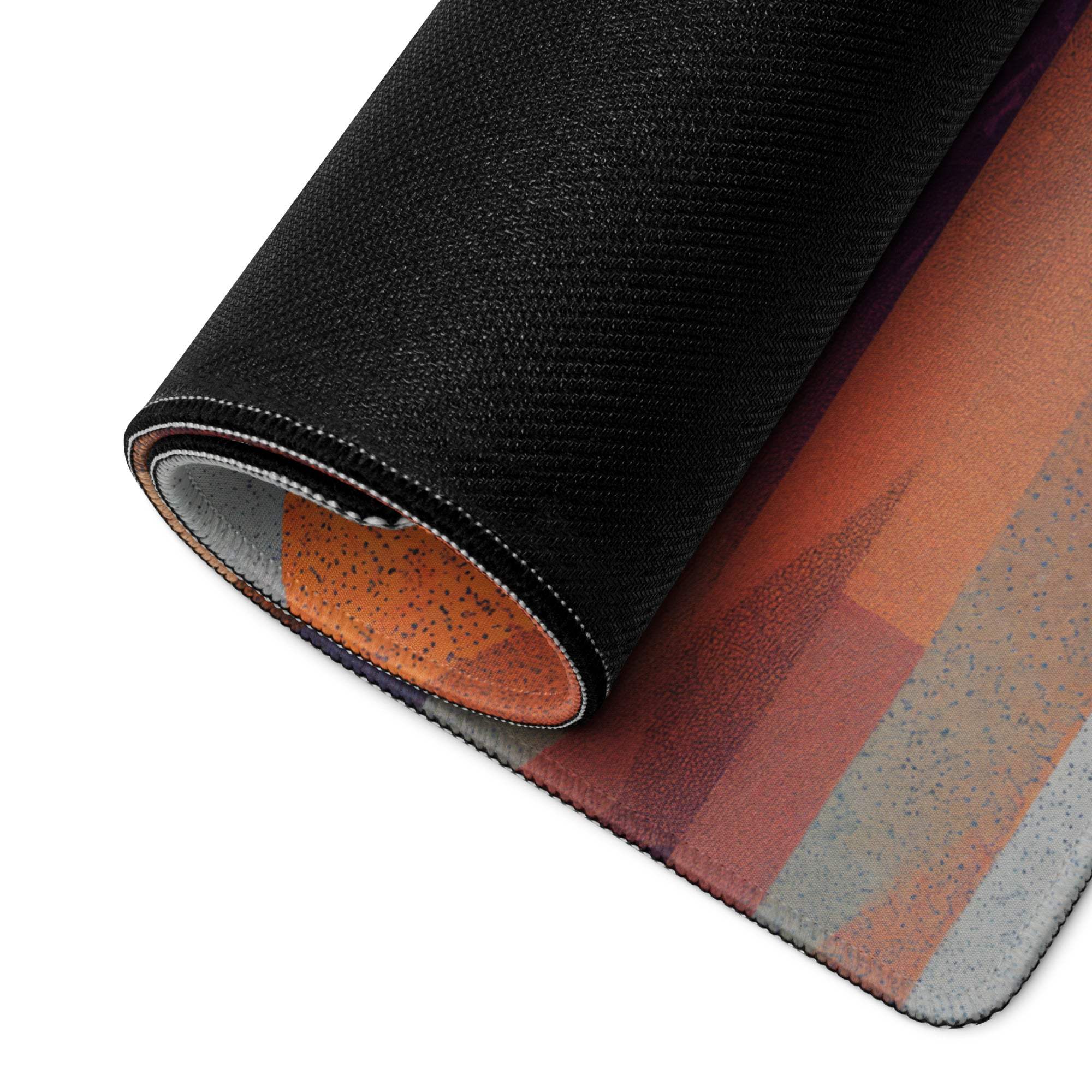 Black textured gaming mouse pad with rolled edge, abstract orange rust gray design, non-slip base