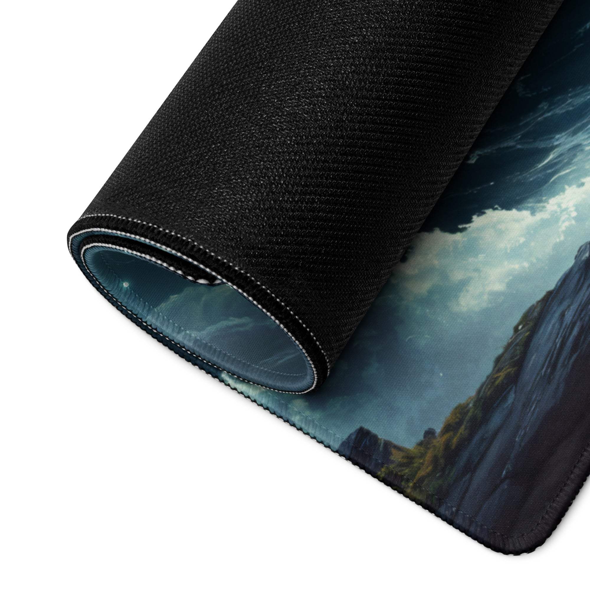 Large black gaming mousepad with stitched edge, stormy mountain print