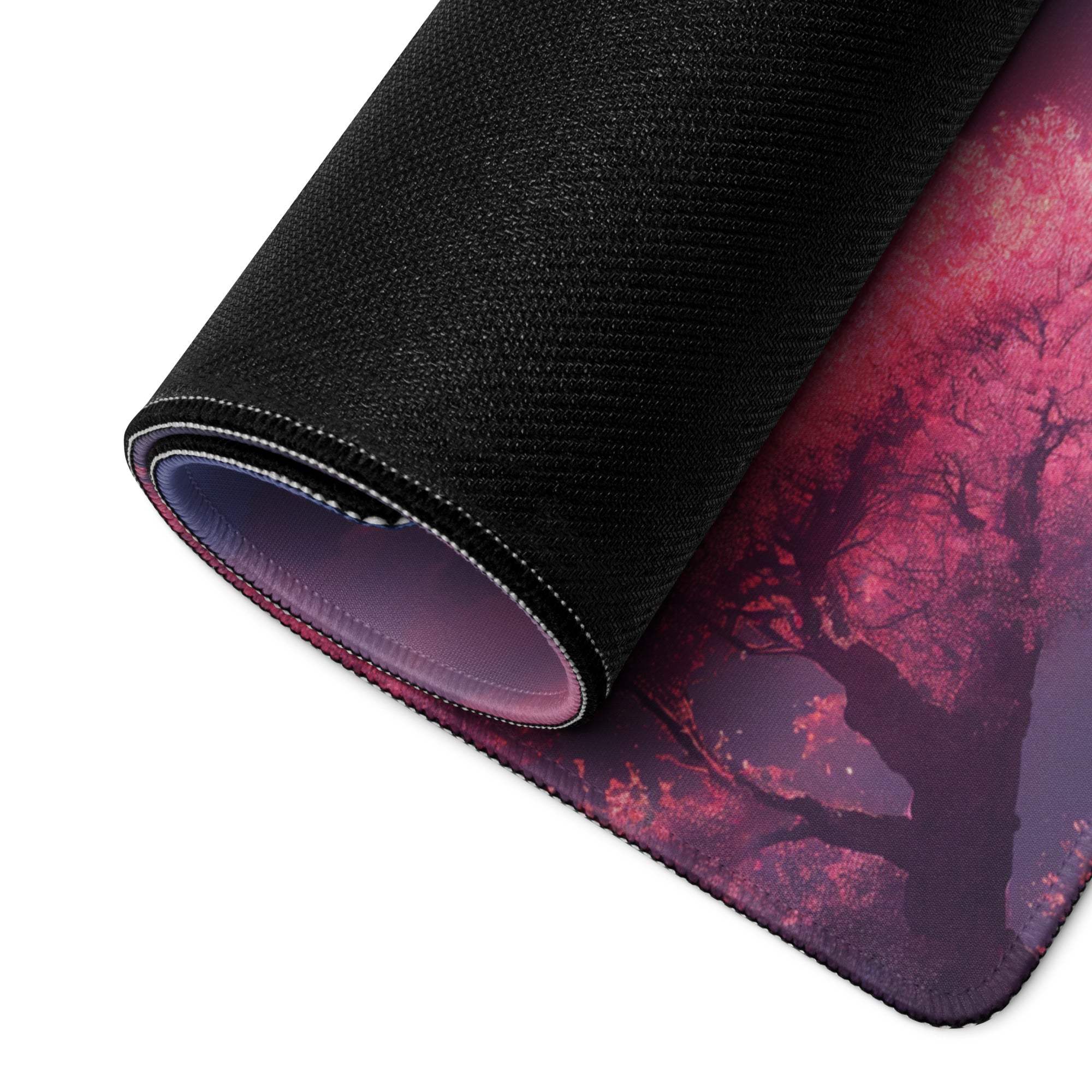 Rolled-up Dreamy Mountain Sunset gaming mouse pad with pink purple tree design
