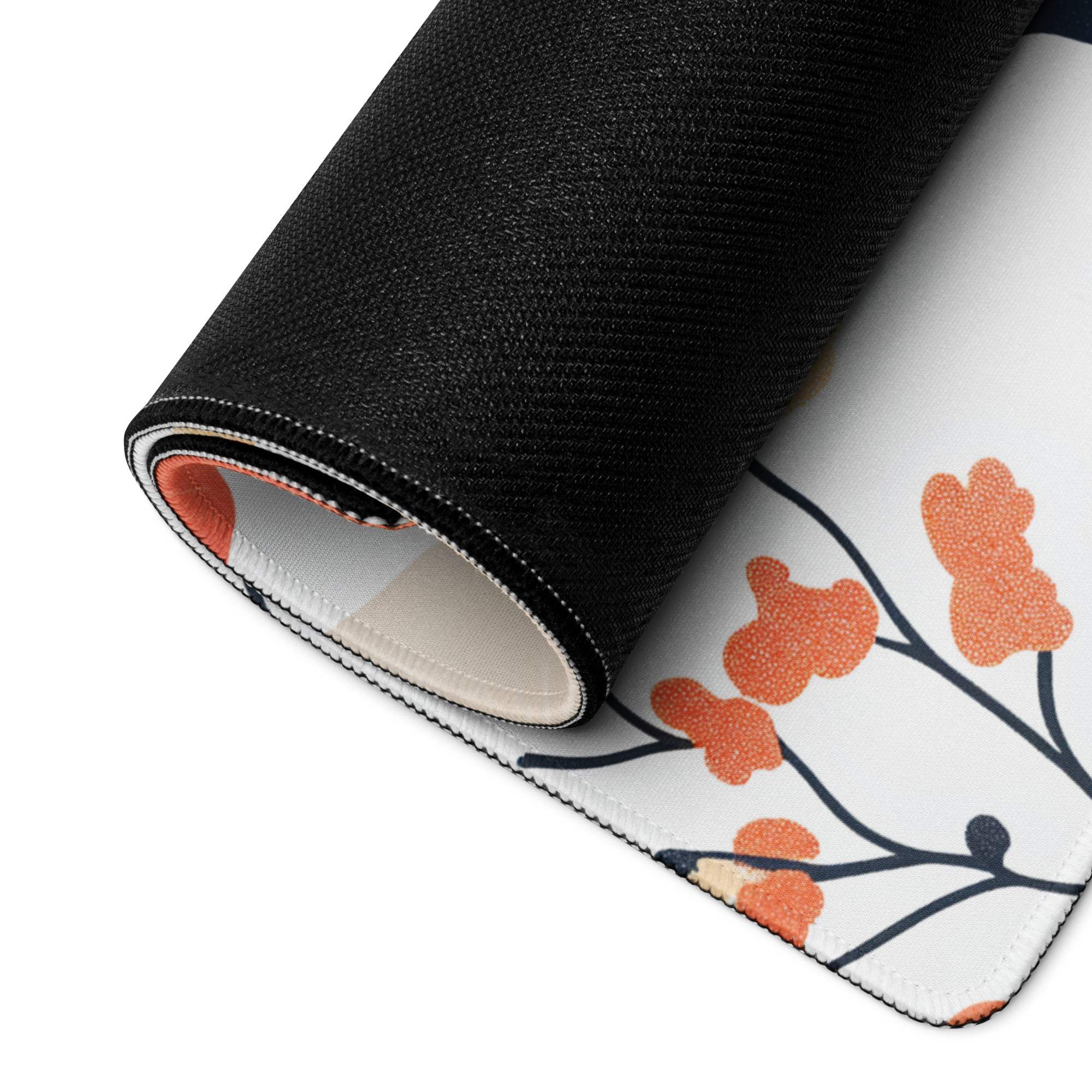 Floral style large gaming mouse pad rolled up with white orange floral pattern