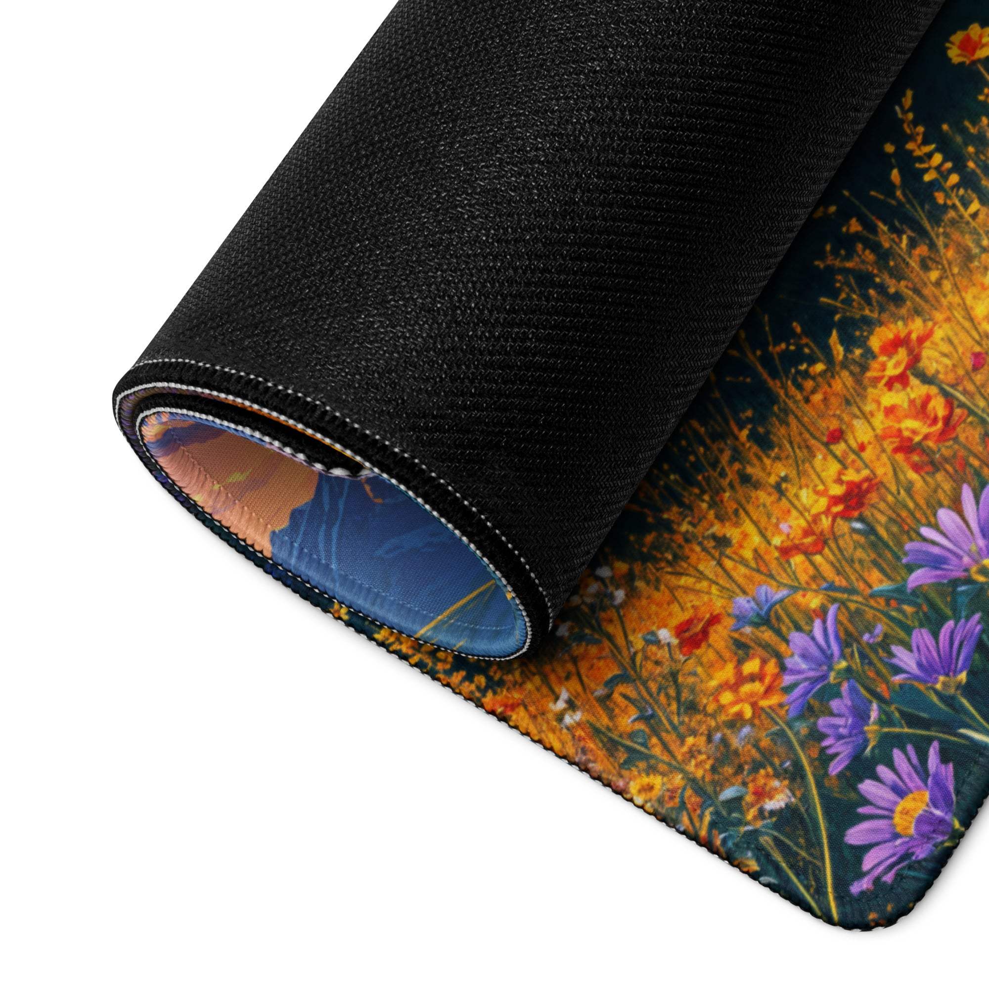 Rolled-up vibrant sunset floral gaming mouse pad with non-slip base