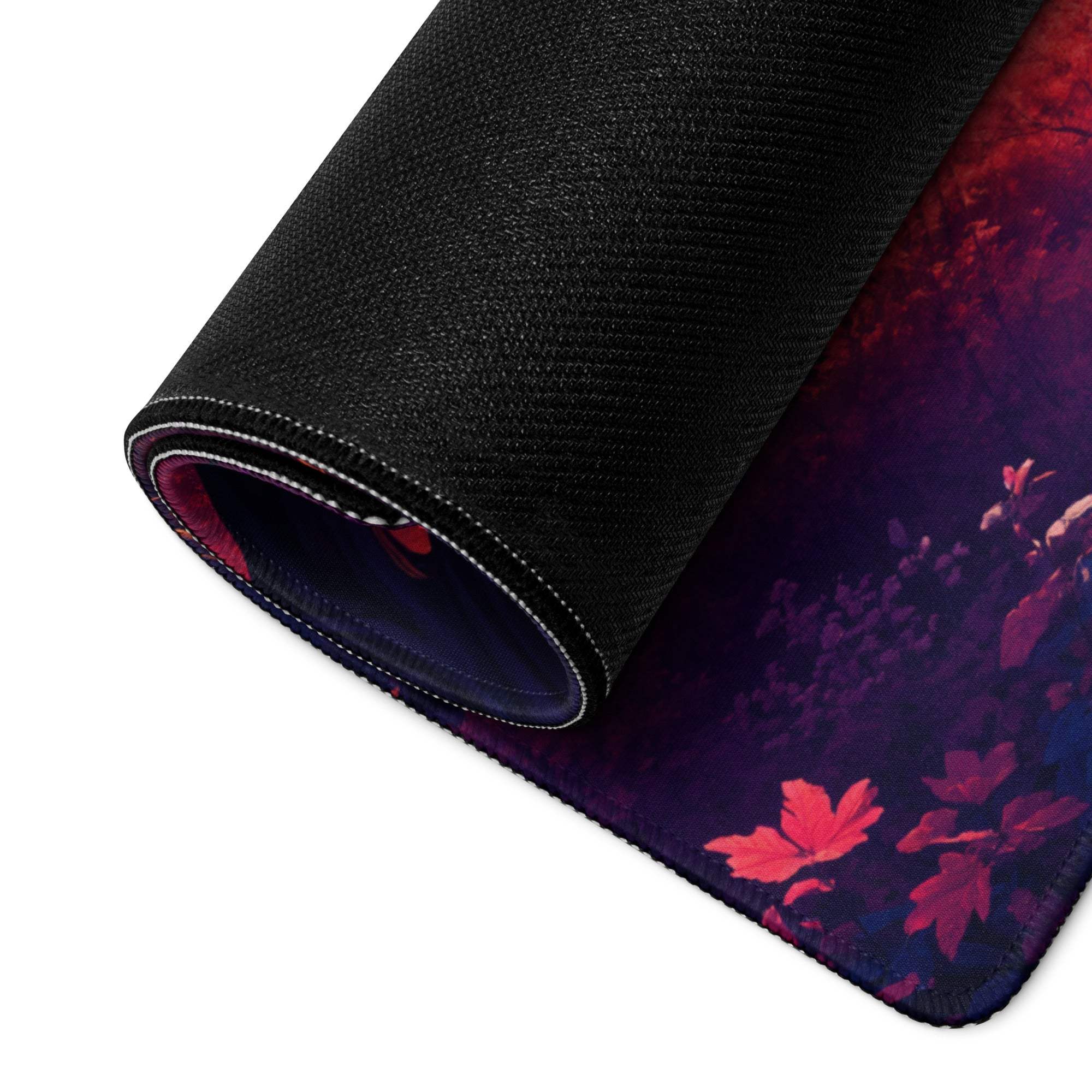 Rolled-up large non-slip gaming mouse pad with vibrant sunset forest leaf design