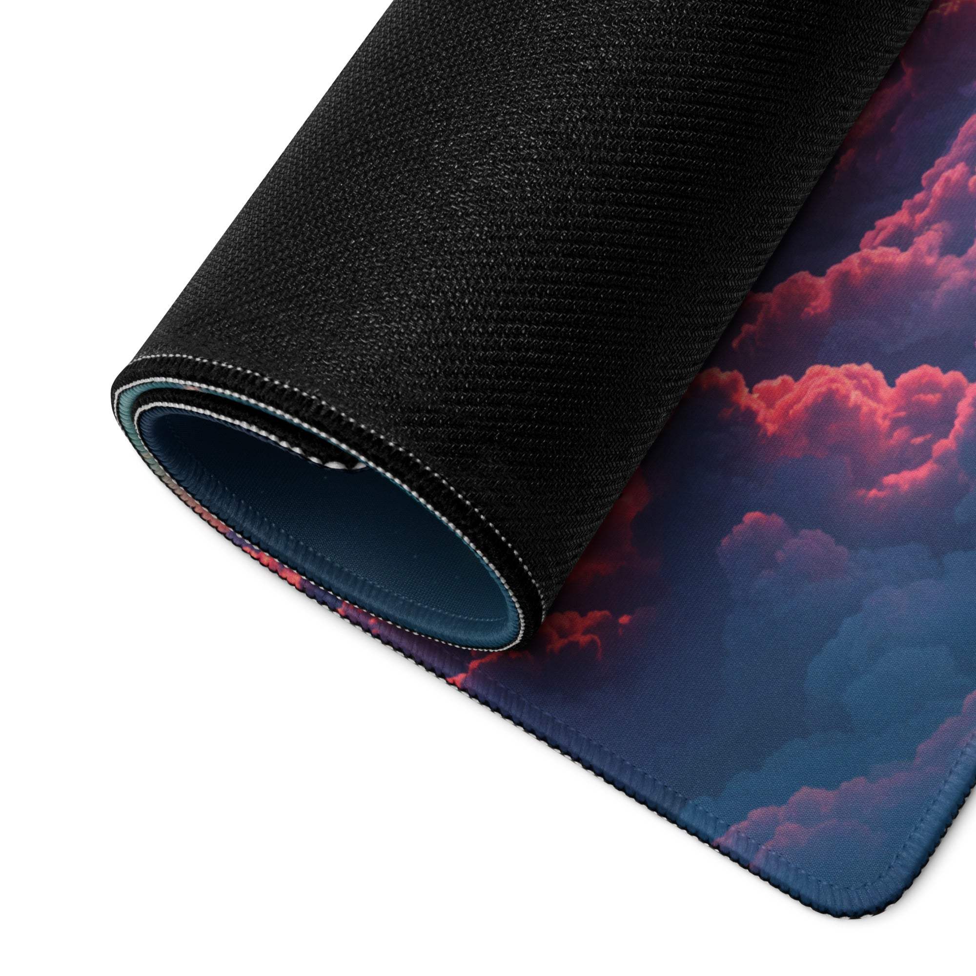 Rolled-up Dreamy Night Sky gaming mouse pad with pink purple clouds