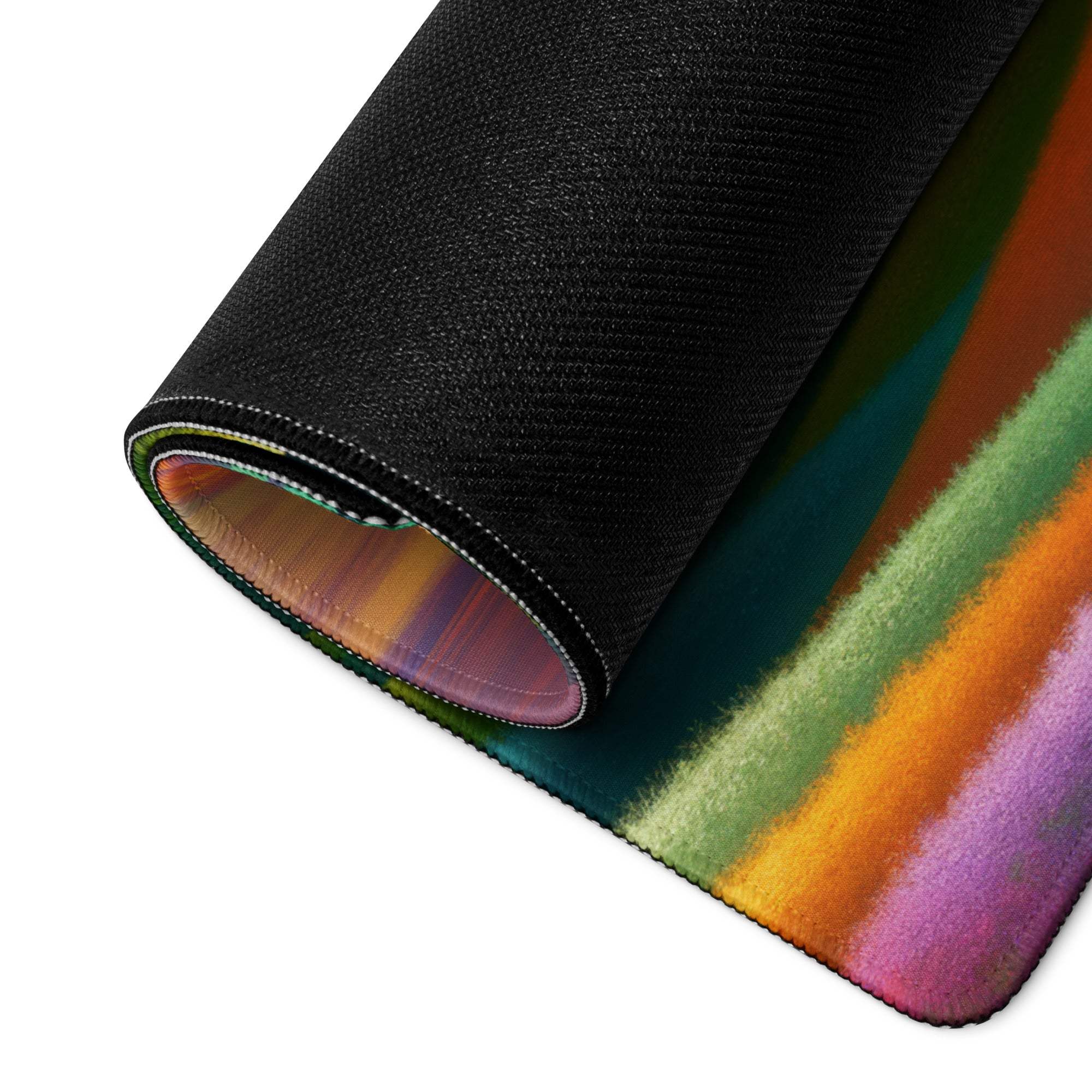 Vibrant rainbow landscape gaming mouse pad rolled up with non-slip black backing