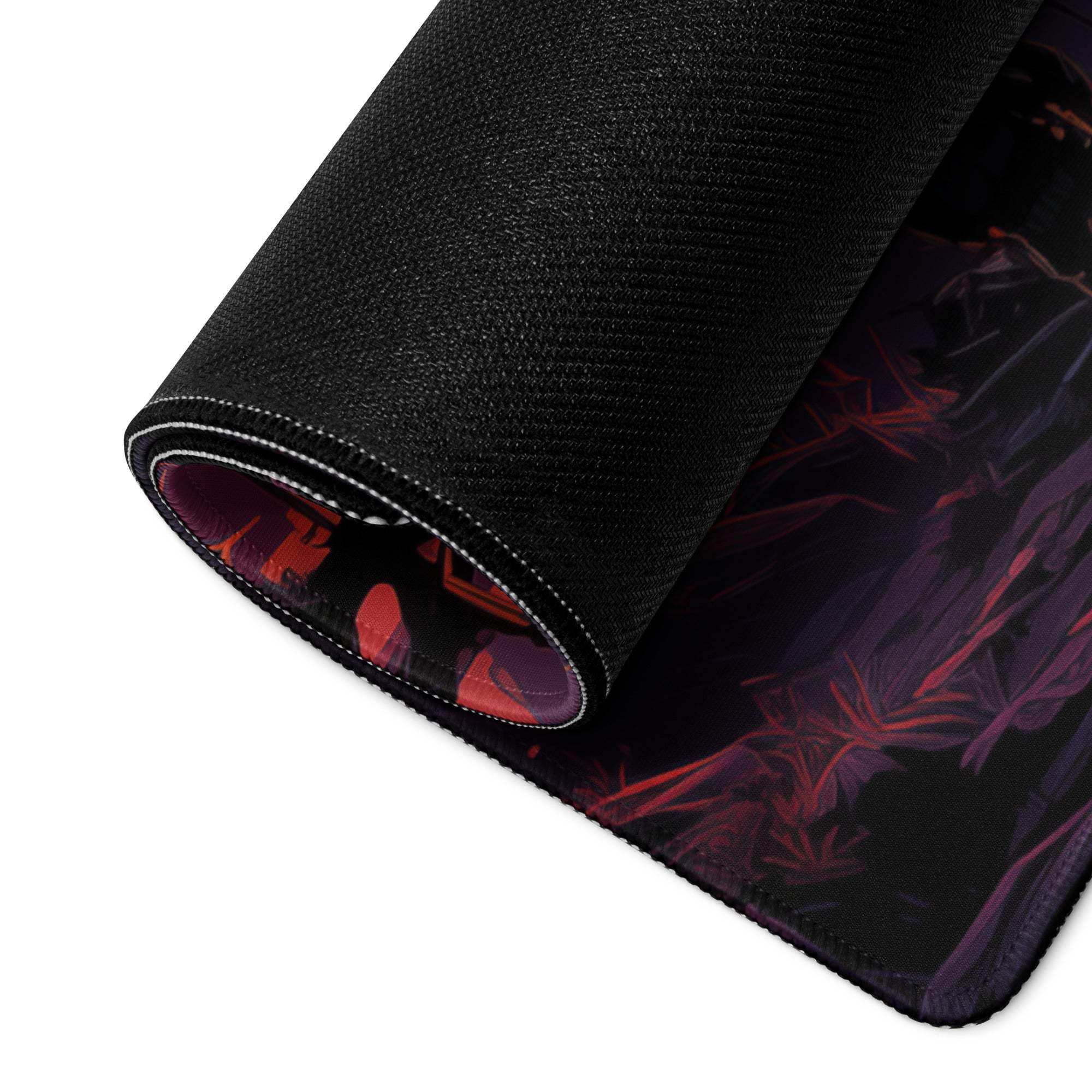 Black textured gaming mousepad rolled edge revealing red purple anime sunset illustration