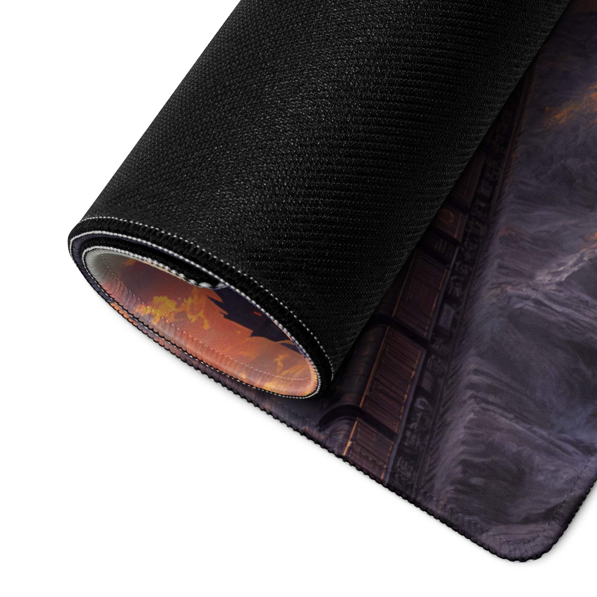 Black textured gaming mousepad rolled edge revealing orange brown dragon over castle sunset design