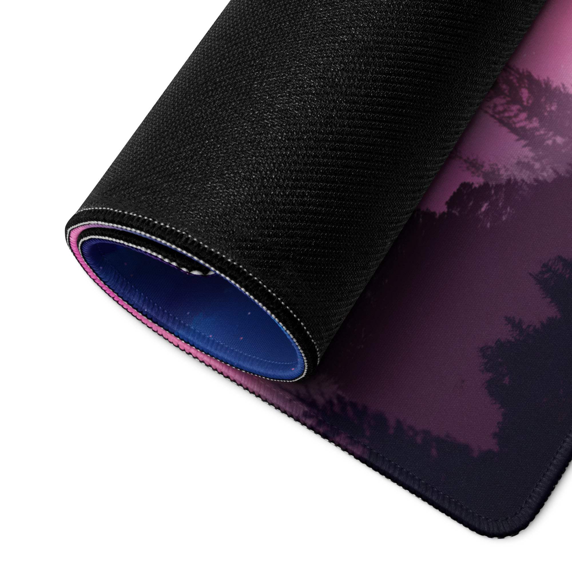 Rolled-up Dreamy Pink Purple Night Sky gaming mouse pad with forest scene