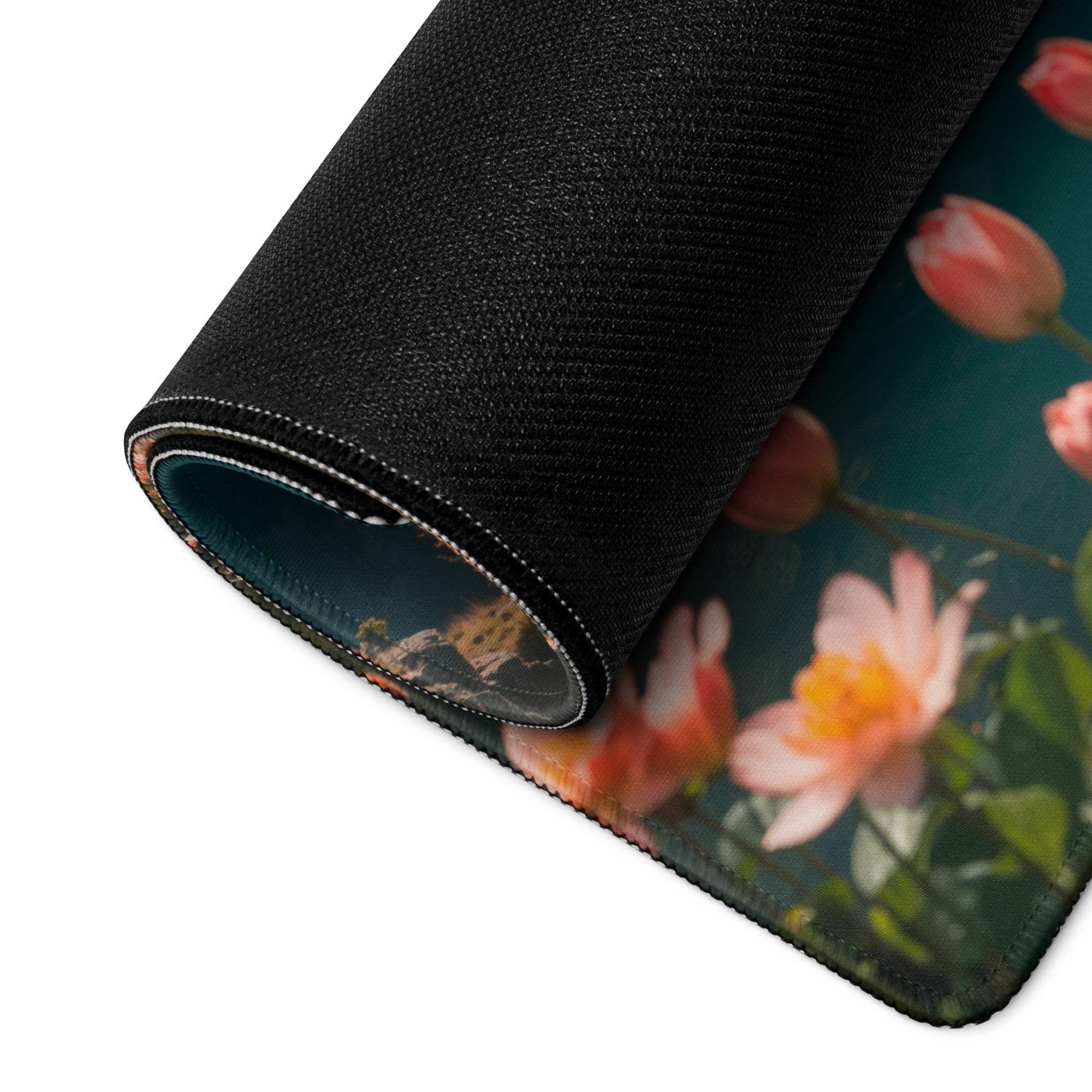 Rolled-up black floral mousepad with pink peach blossoms on teal, Epic Misty Blue gaming pad