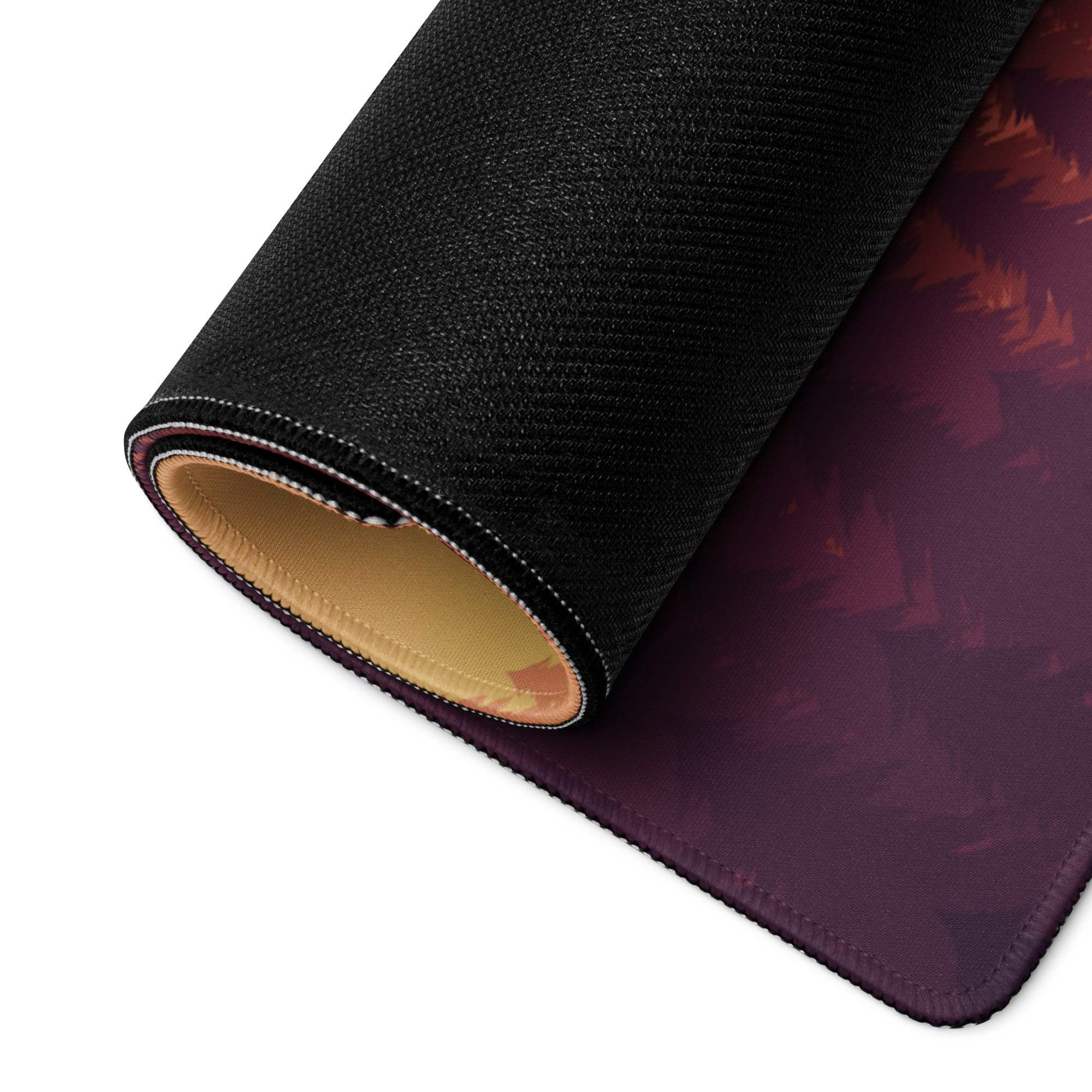 Rolled-up Epic Sunset Mountain Forest gaming mouse pad, black textured back