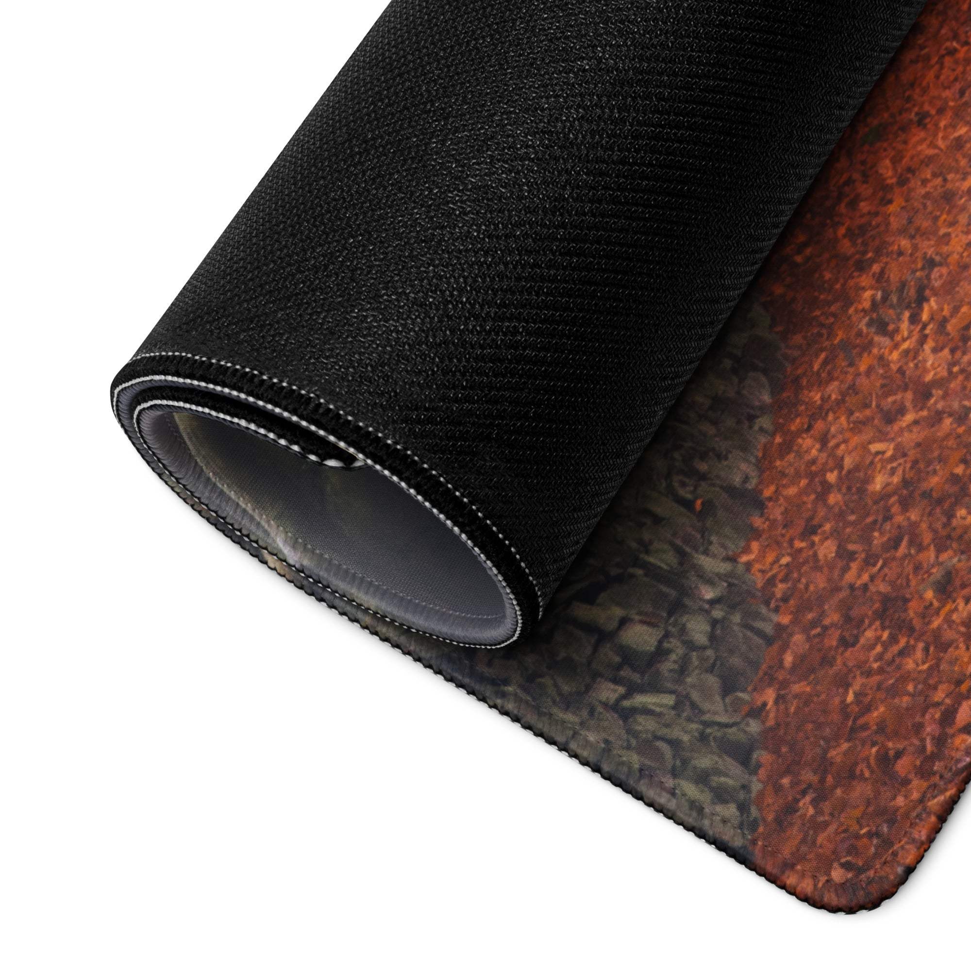 Black textured gaming mousepad with orange gray stone design and rolled edge