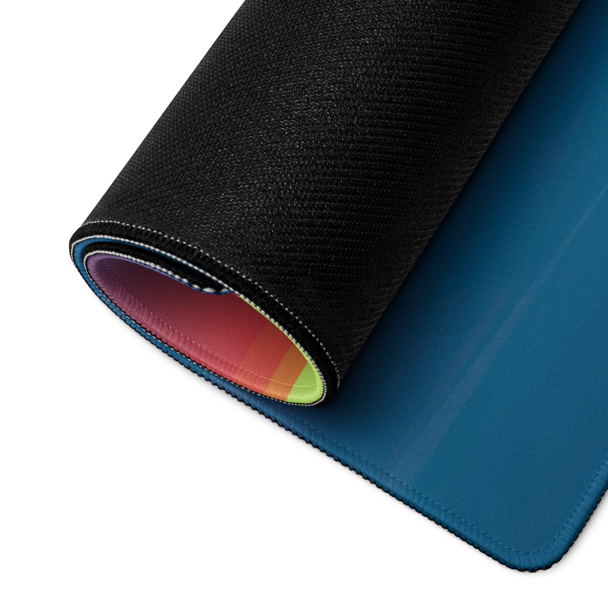 Large Calm Coastal Sunset gaming mouse pad back: black textured with rainbow lining, blue edge