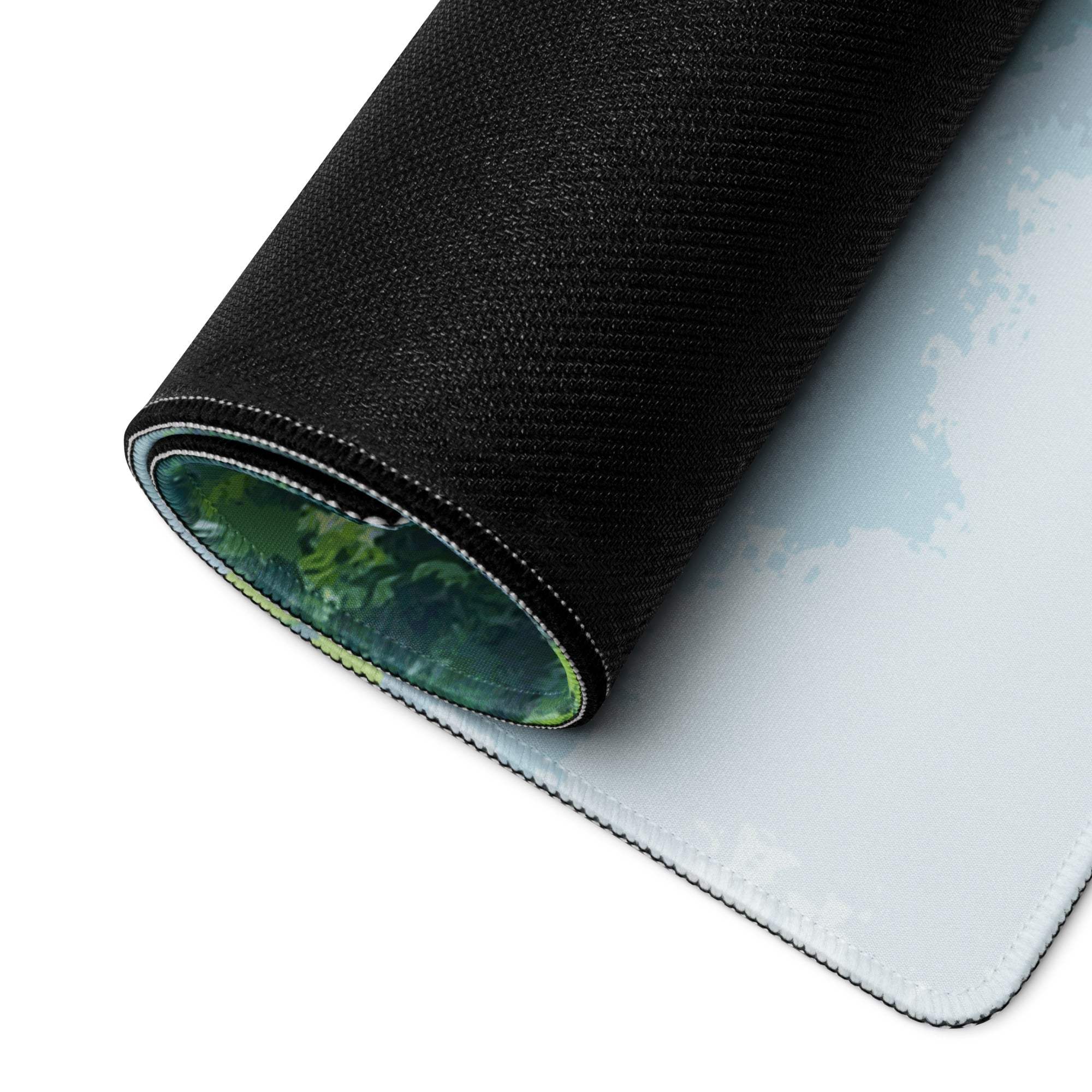Back of Tranquil Waterfall gaming mouse pad with black textured underside and green forest design