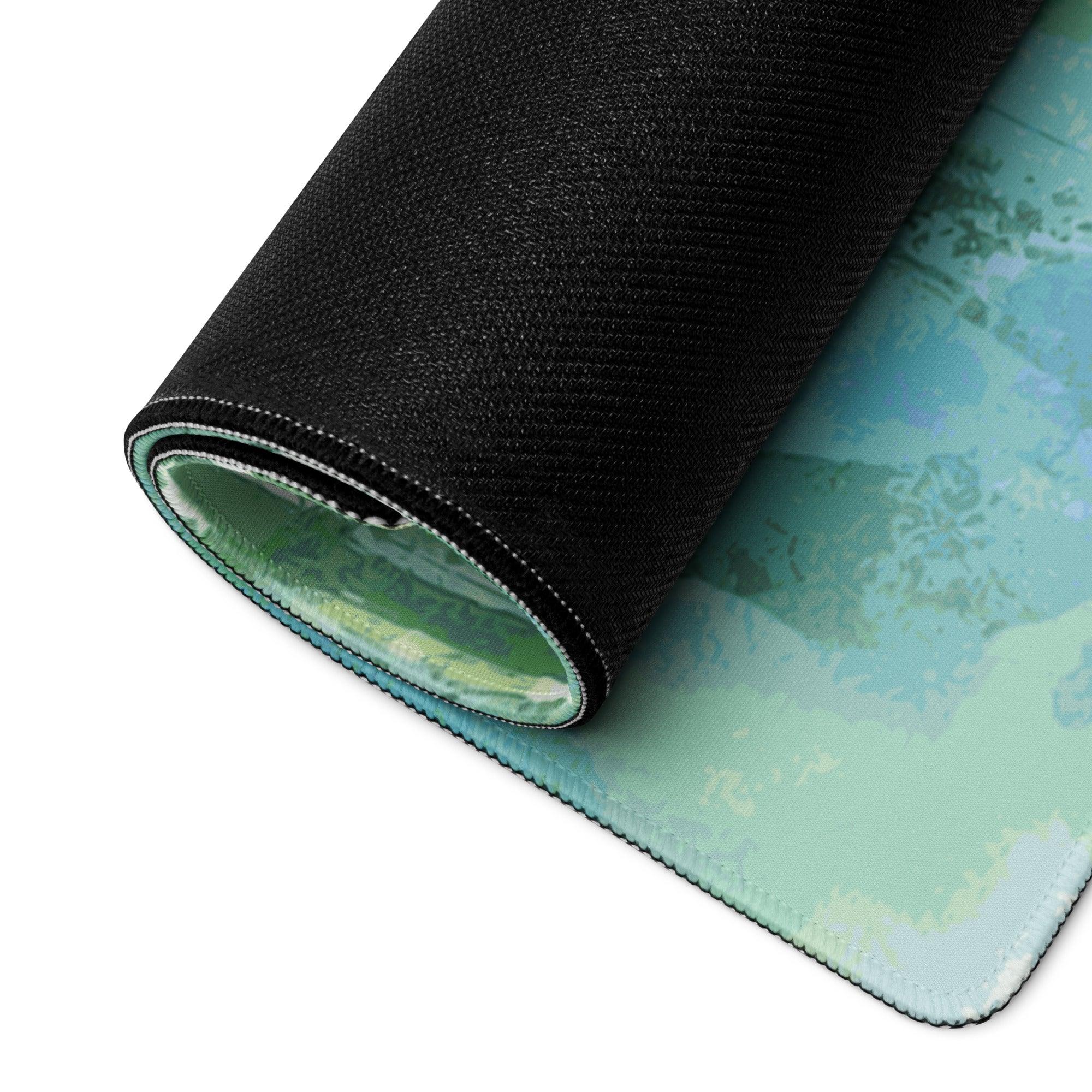 Rolled-up watercolor forest green blue gaming mouse pad with teal edge