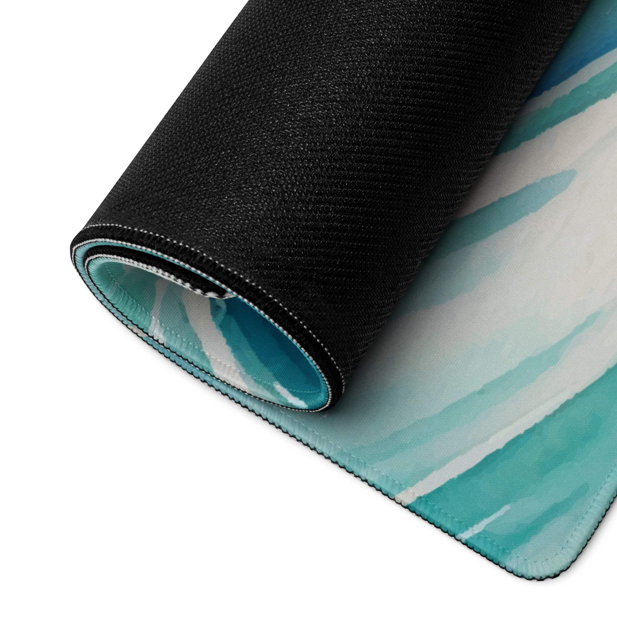 Rolled-up teal watercolor ocean wave gaming mousepad, black textured back