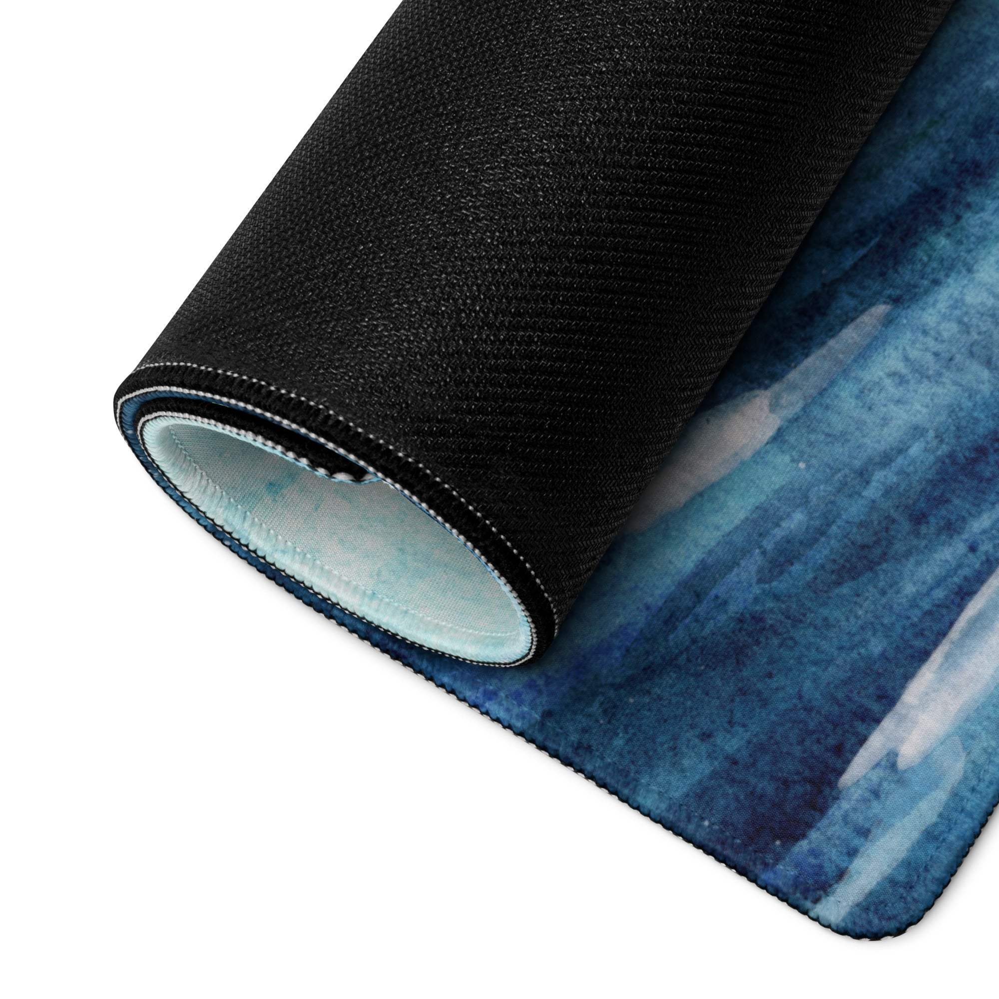 Blue watercolor ocean wave gaming mouse pad with textured edges and non-slip backing