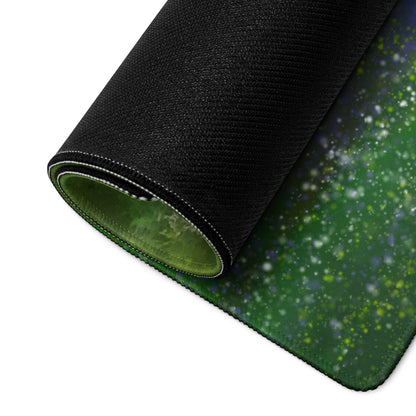 Rolled-up green galaxy gaming mouse pad with black edge and white stitching