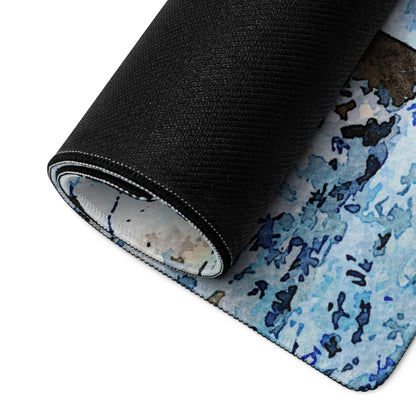 Rolled-up Winter Forest gaming mouse pad with blue watercolor design