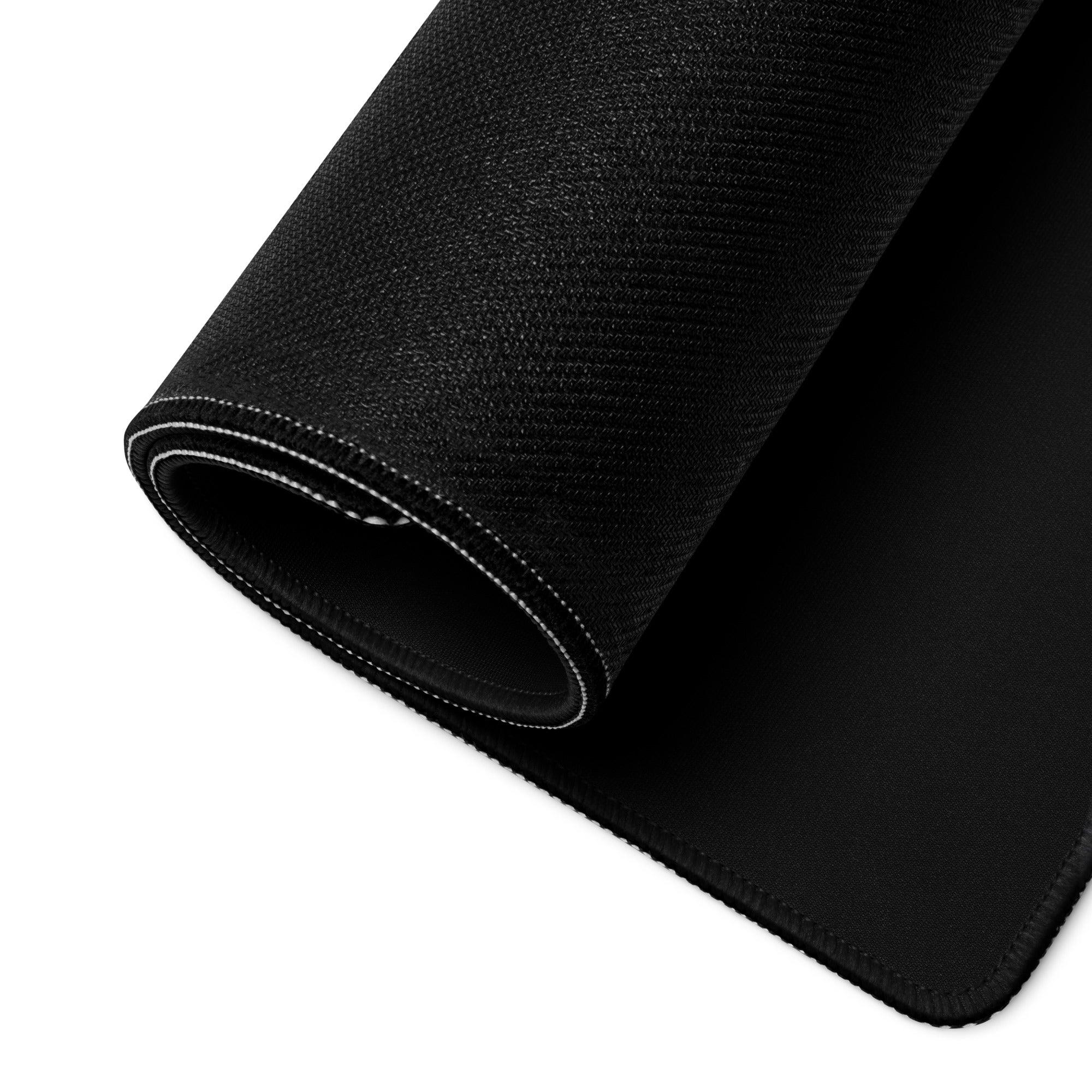 Black textured gaming mousepad with white stitched edges and non-slip base