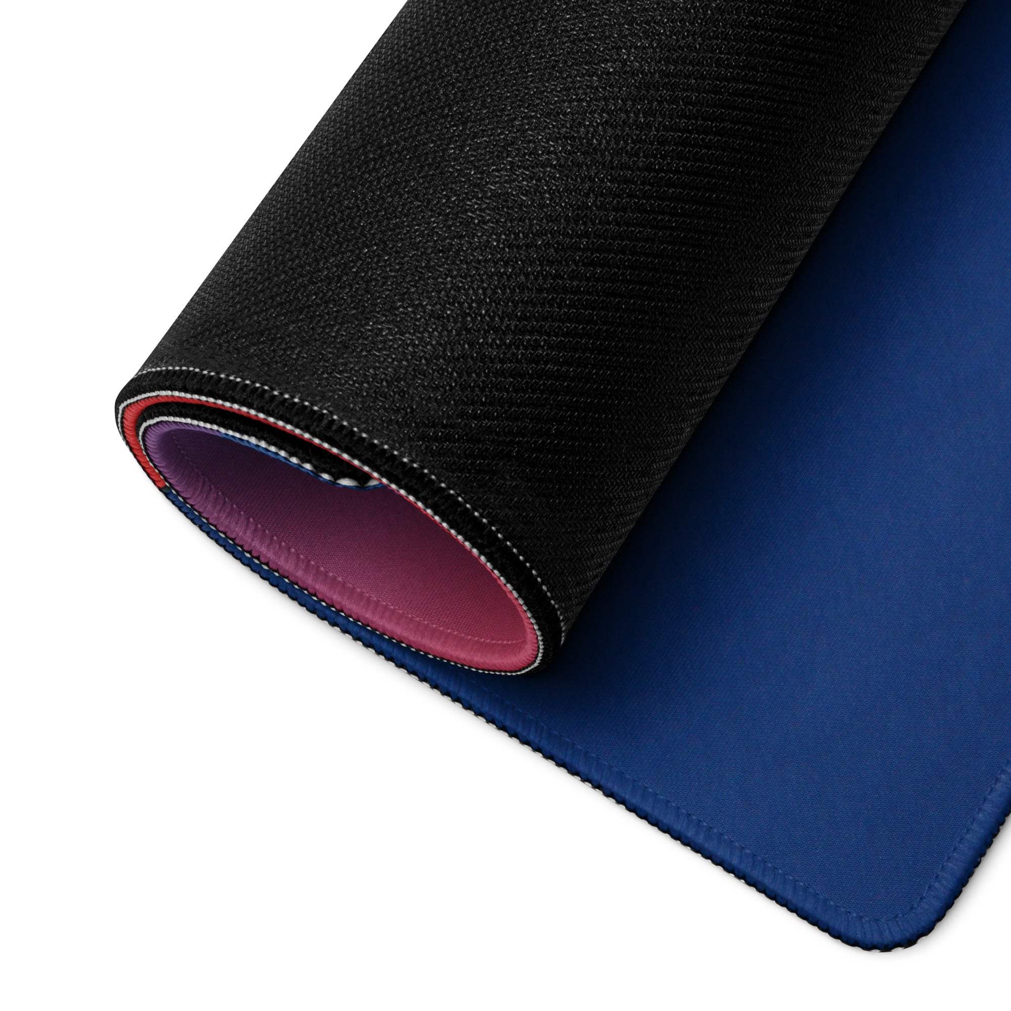 Rolled geometric gaming mouse pad with black textured outer, blue inner, pink lining