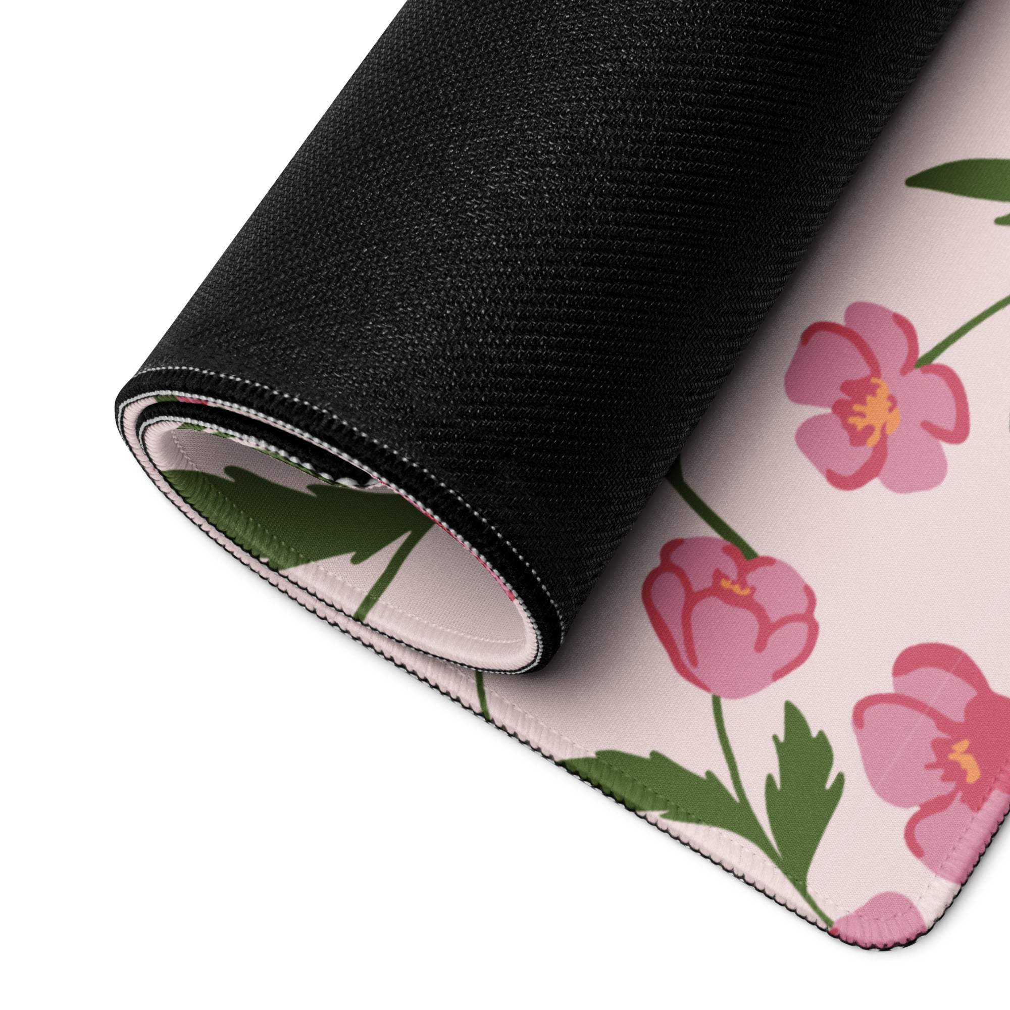 Pink floral gaming mouse pad with black stitched edges and non-slip backing