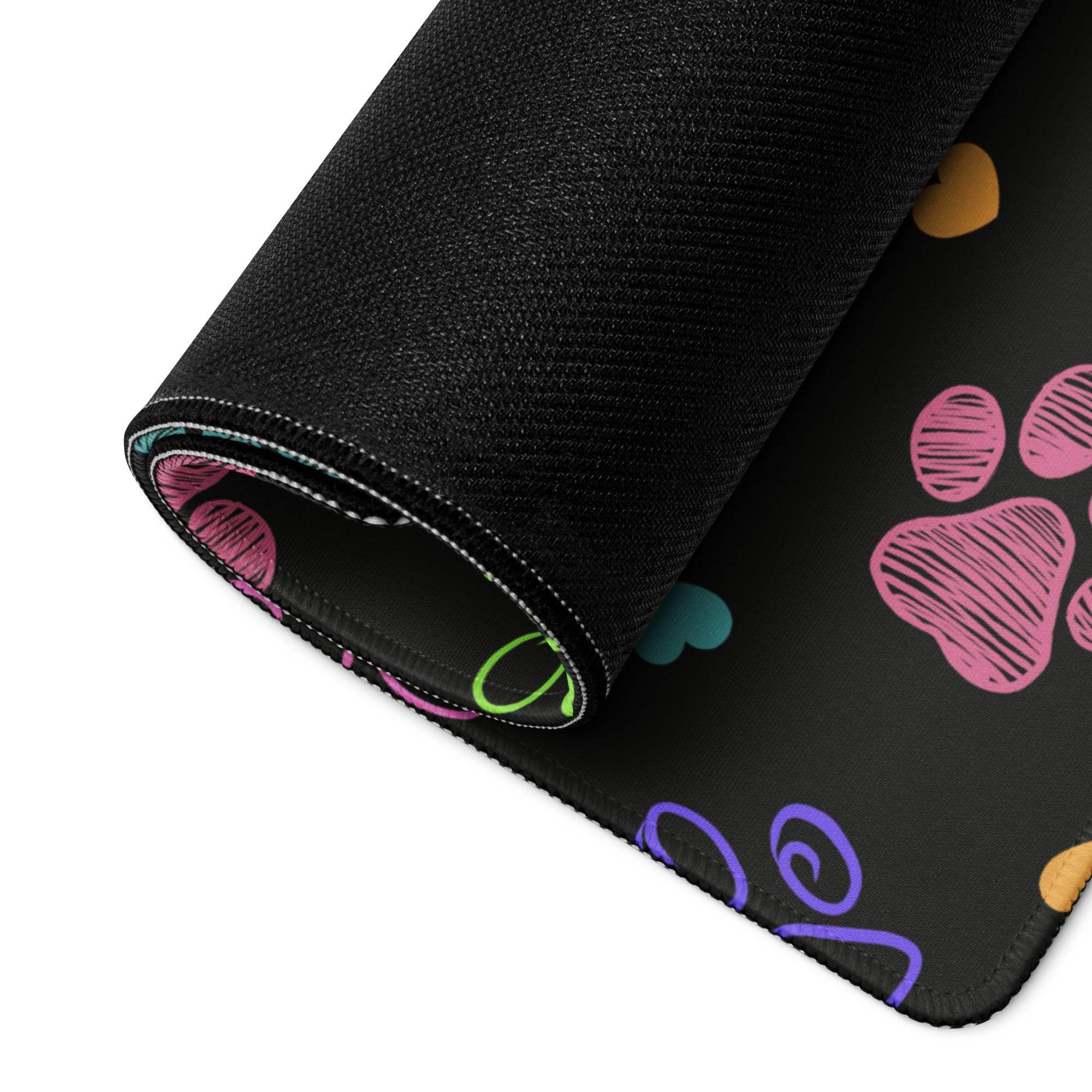Large colorful paw print gaming mouse pad with non-slip base, black textured surface