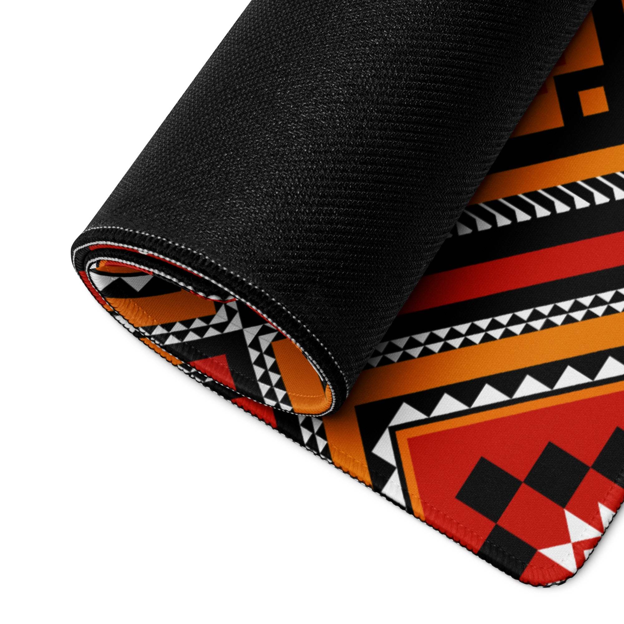 Rolled-up Vibrant Tribal Geometric Diamond gaming mouse pad in bold red orange black white
