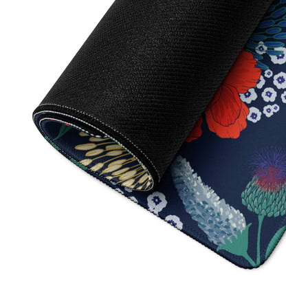 Rolled-up floral navy blue gaming mouse pad with red poppies and stitched edge