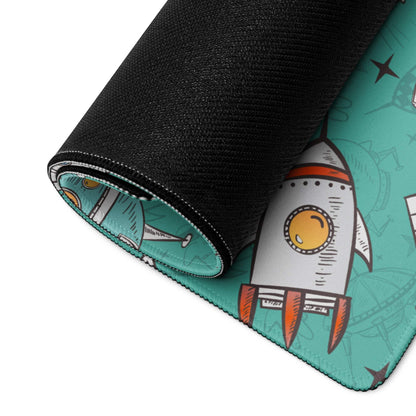 Teal gaming mouse pad with playful rocket design and non-slip base