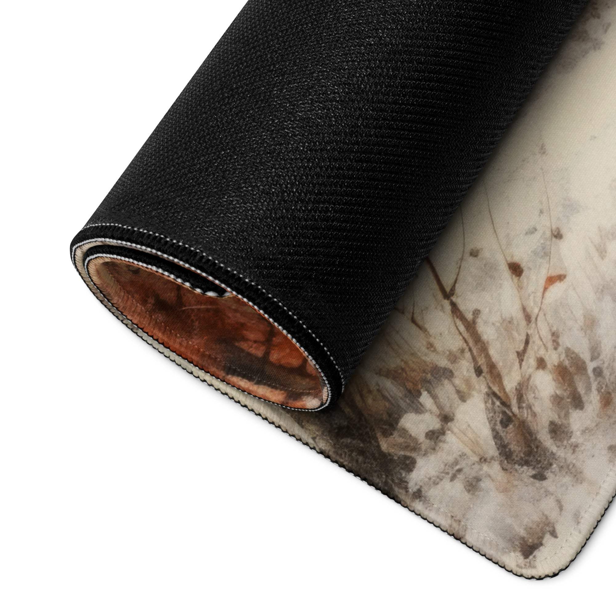 Black textured gaming mousepad rolled edge reveals earth-toned abstract design