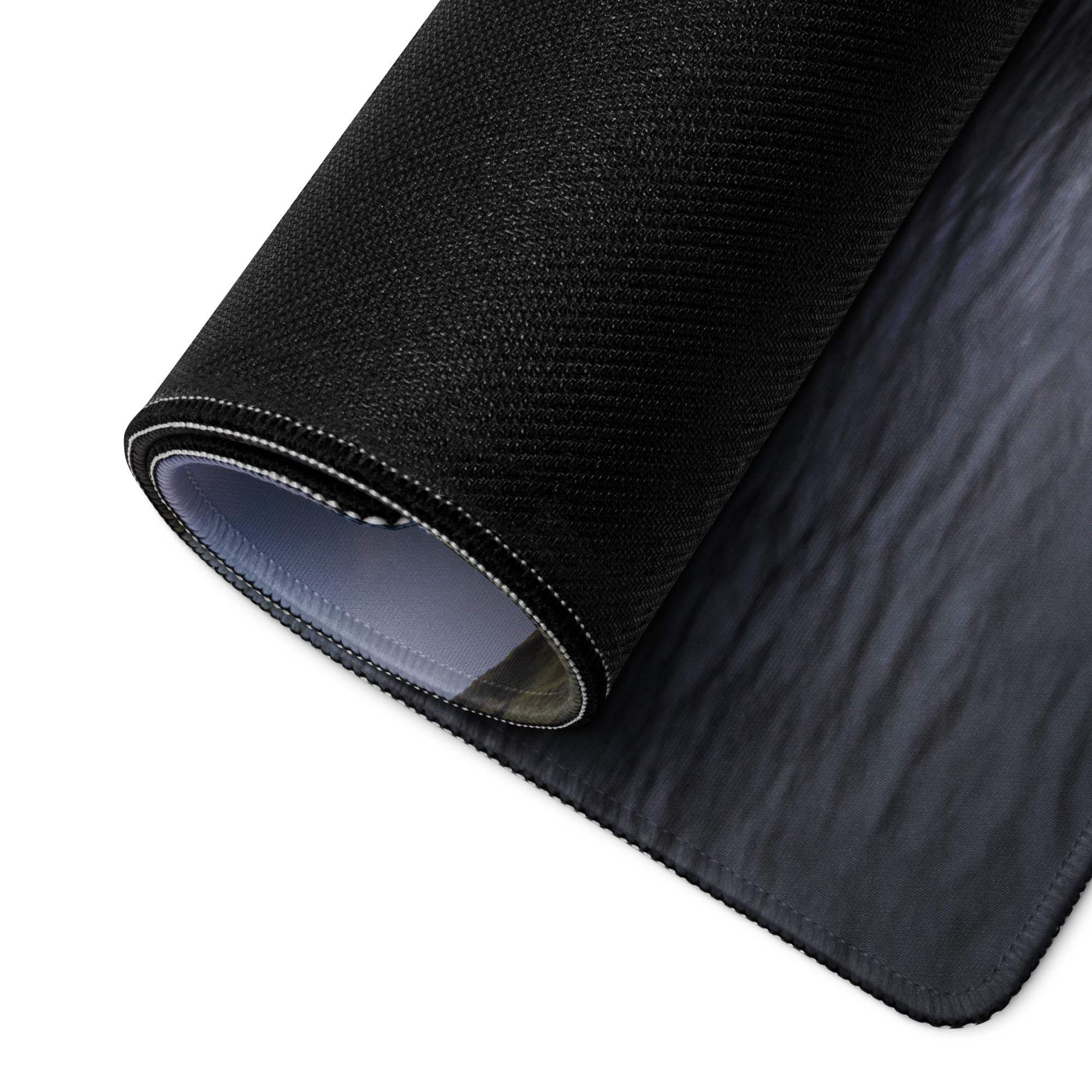 Back of premium large scenic sunset gaming mouse pad with black textured top, gray non-slip underside and stitched edges