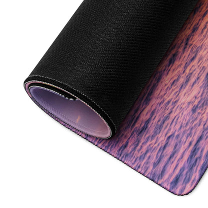 Rolled-up Sunset Ocean Vibe gaming mouse pad with purple pink wood-grain design