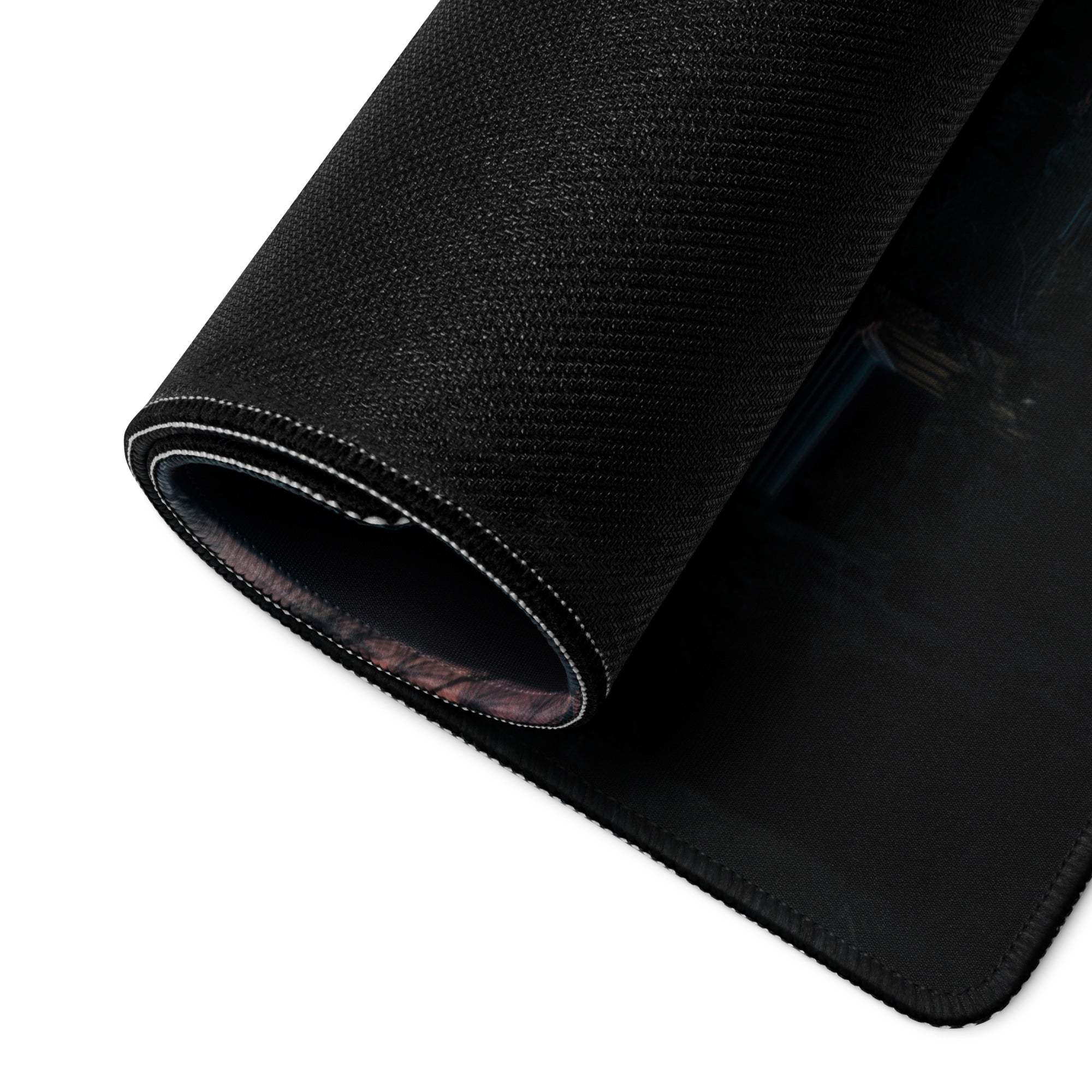 Underside of Sunset Forest large gaming mouse pad with black textured non-slip base and stitched edges