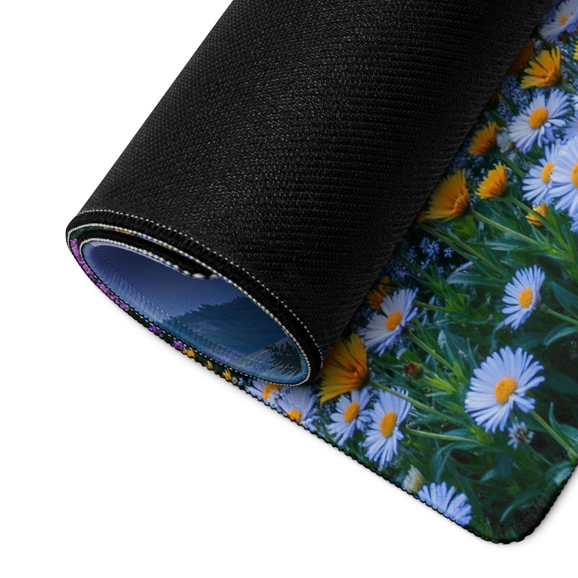Black rolled-up mousepad with daisies, lake landscape, non-slip backing