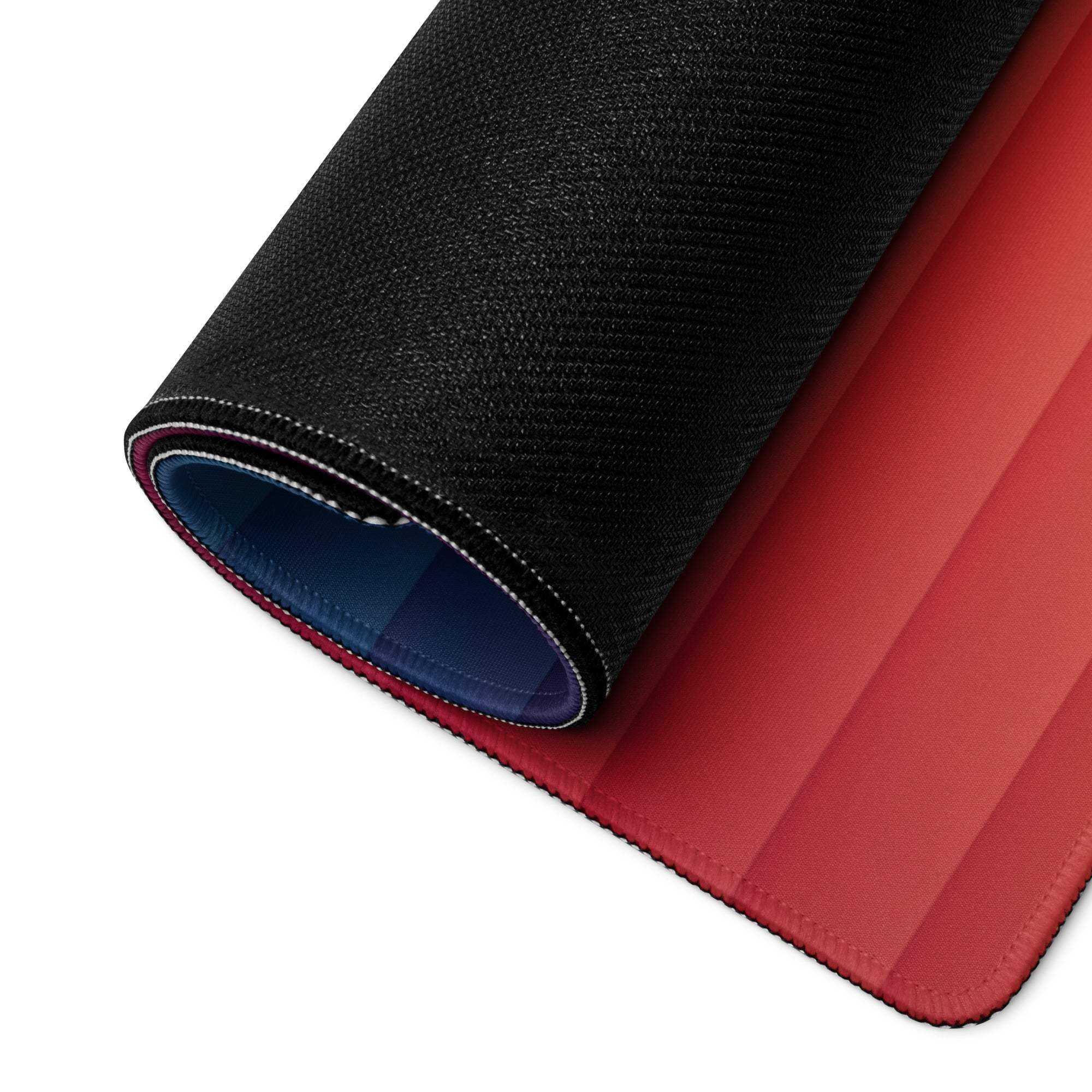 Back of large gradient rainbow gaming mouse pad with black textured outer layer, red blue lining, rolled display
