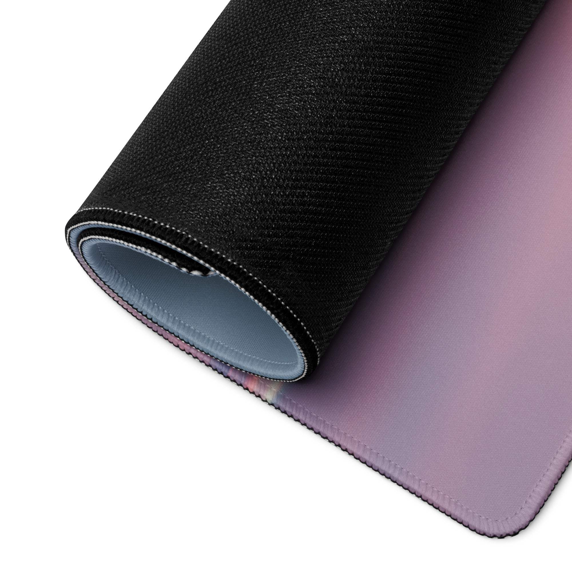 Rolled-up black lavender gradient gaming mousepad with stitched edges