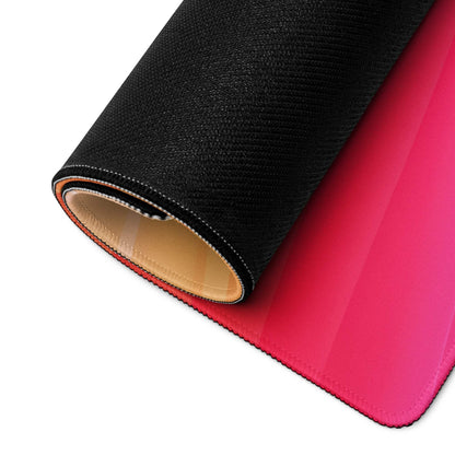 Rolled-up vibrant sunset gradient gaming mouse pad with pink texture and stitching