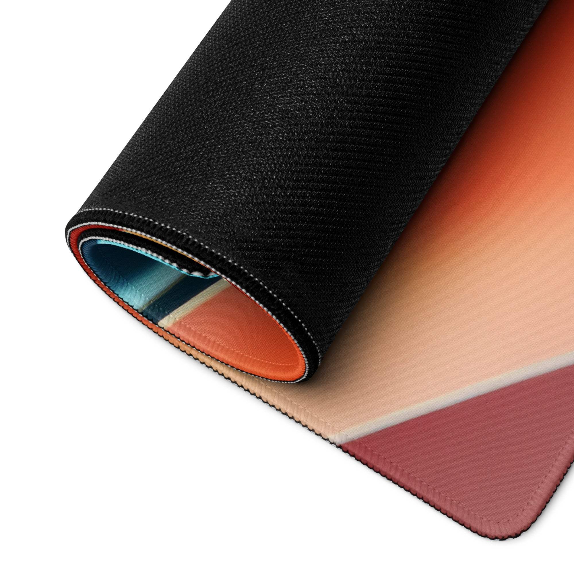 Rolled-up gaming mousepad with orange, peach, rose pink gradient and vibrant blues