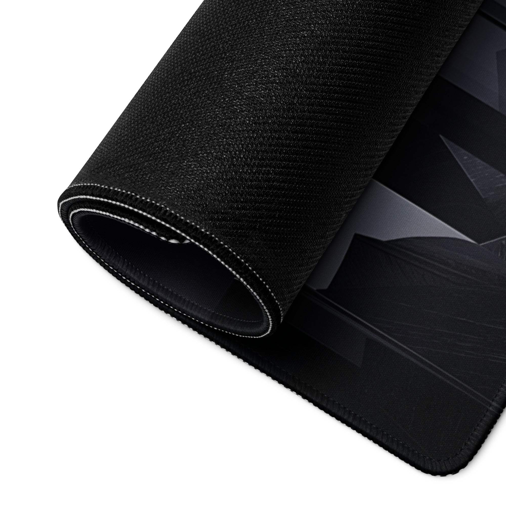 Black textured large gaming mousepad with geometric design, white stitched edge