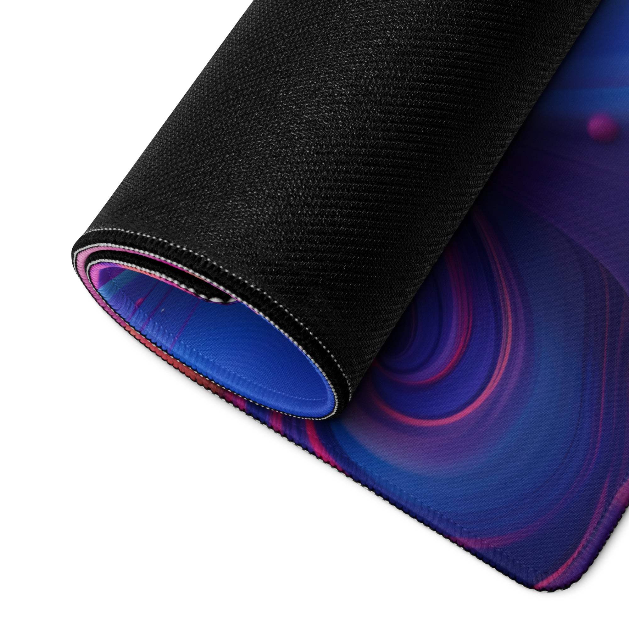 Rolled-up Abstract Vibrant Swirl gaming mouse pad with cosmic design and non-slip base