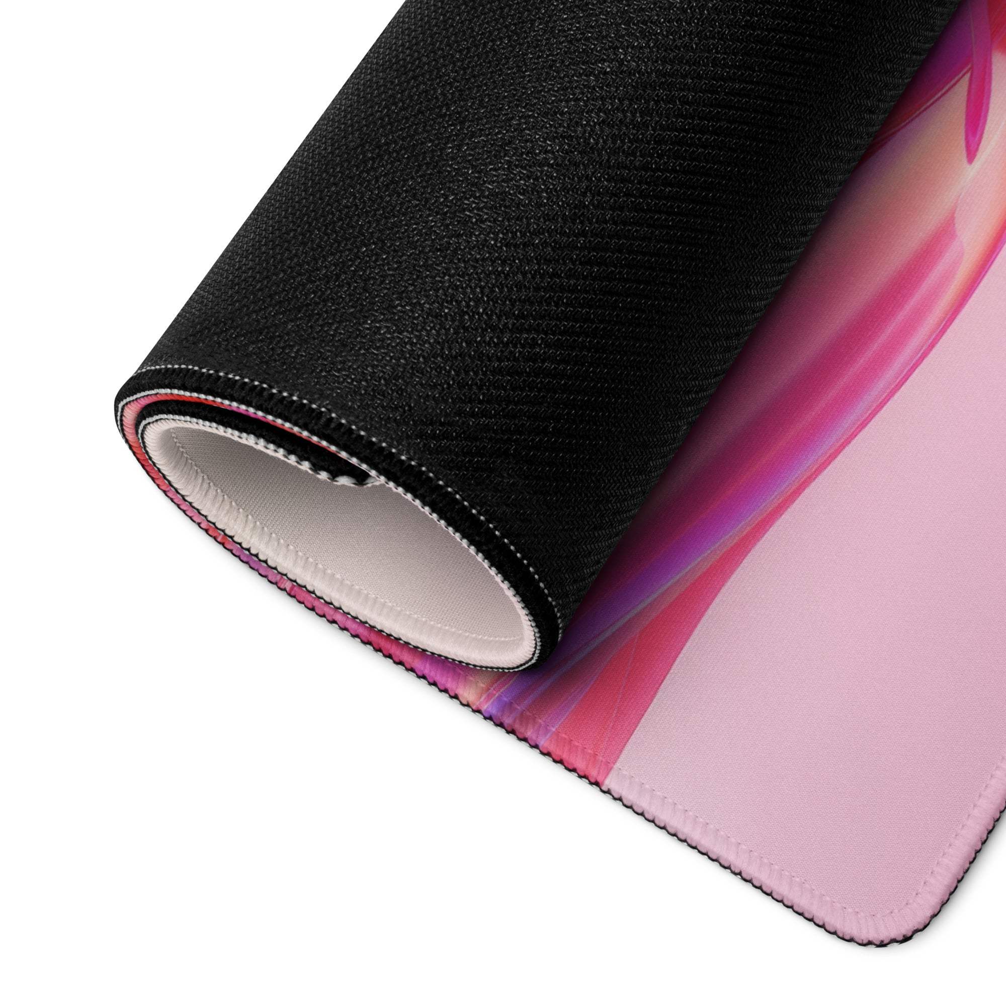 Rolled-up vibrant pink purple gradient gaming mousepad with black textured edges