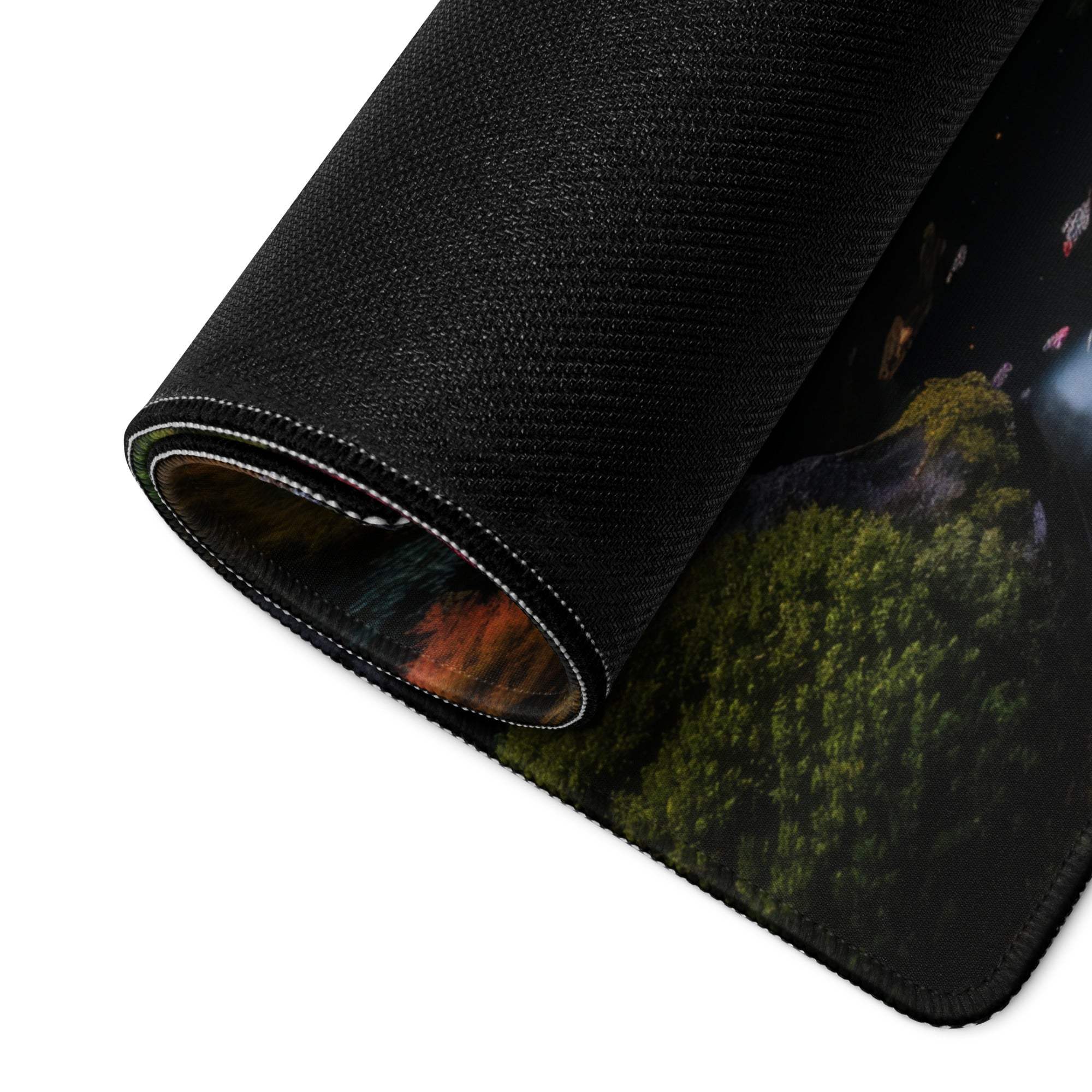 Black textured gaming mousepad with forest mountain design, rolled edge, non-slip base