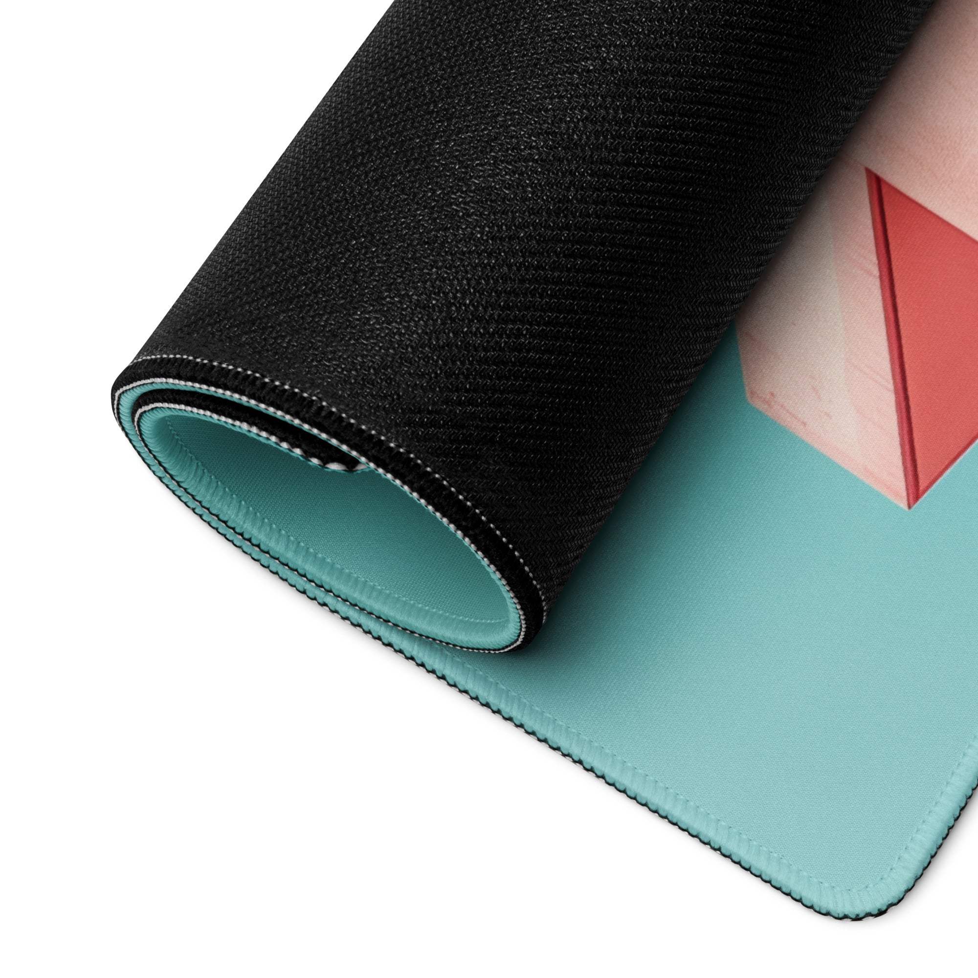 Rolled-up teal and pink minimalist gaming mouse pad with geometric red triangles