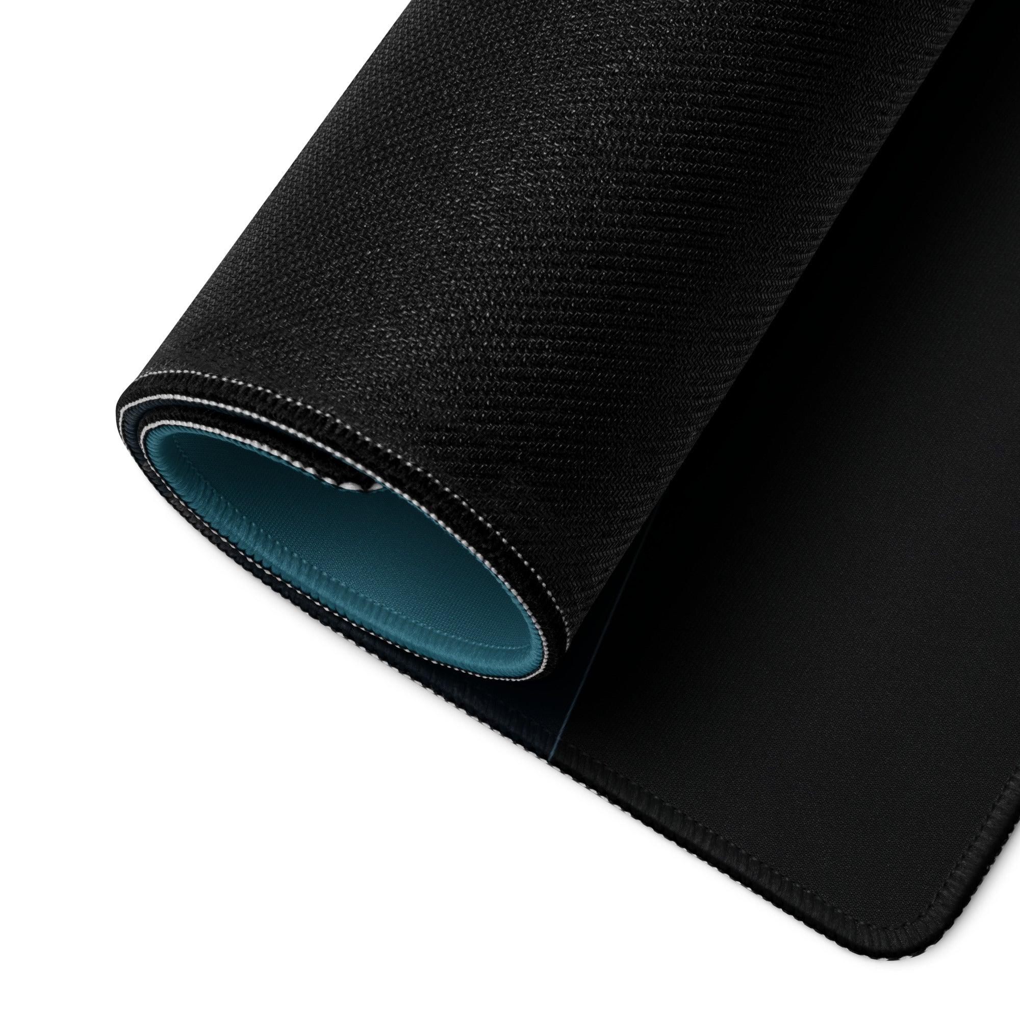 Black textured gaming mouse pad back with teal lining, stitched edges